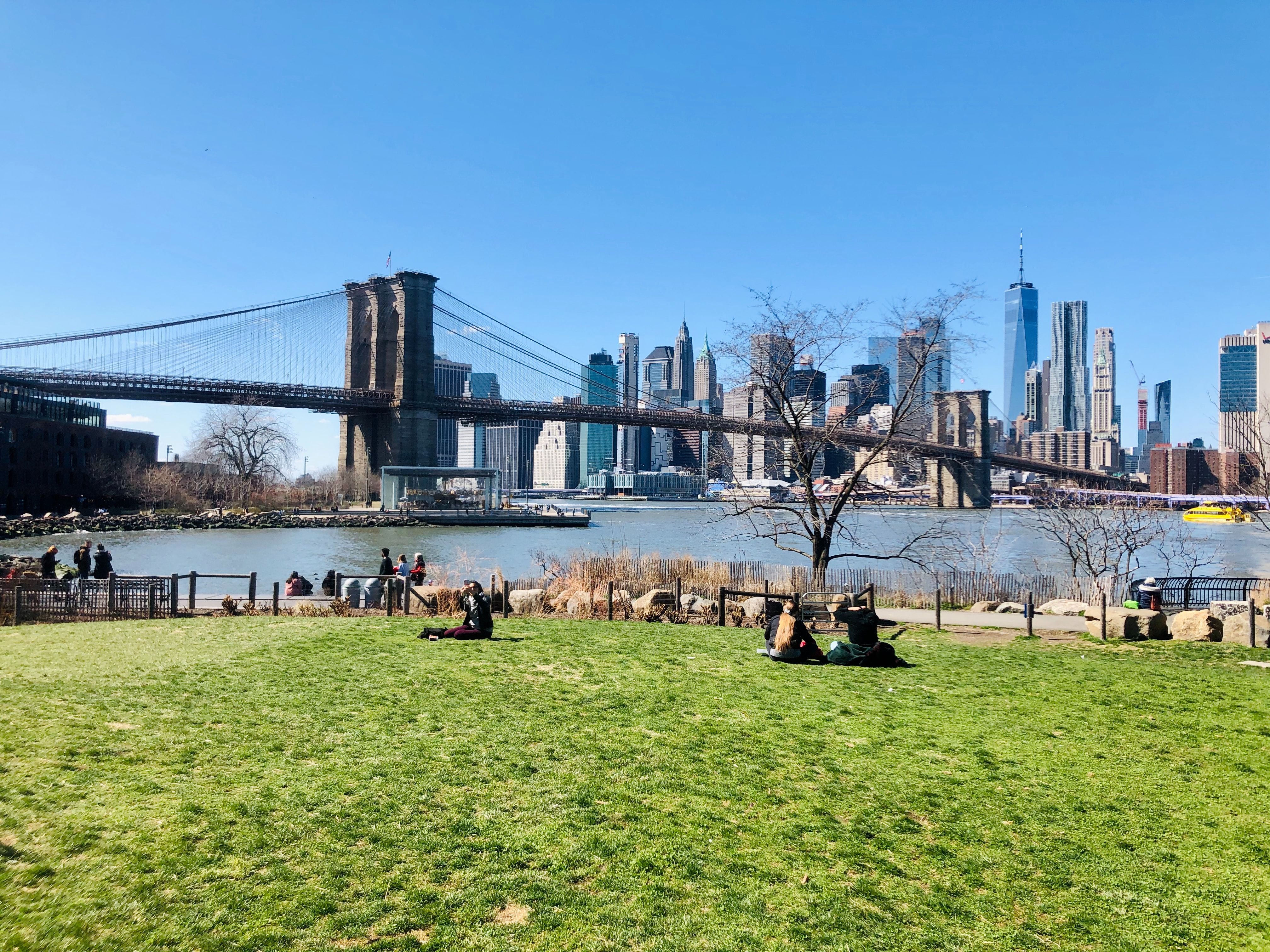People enjoying a view of Manhattan from Dumbo, Brooklyn at the Brooklyn Bridge Park