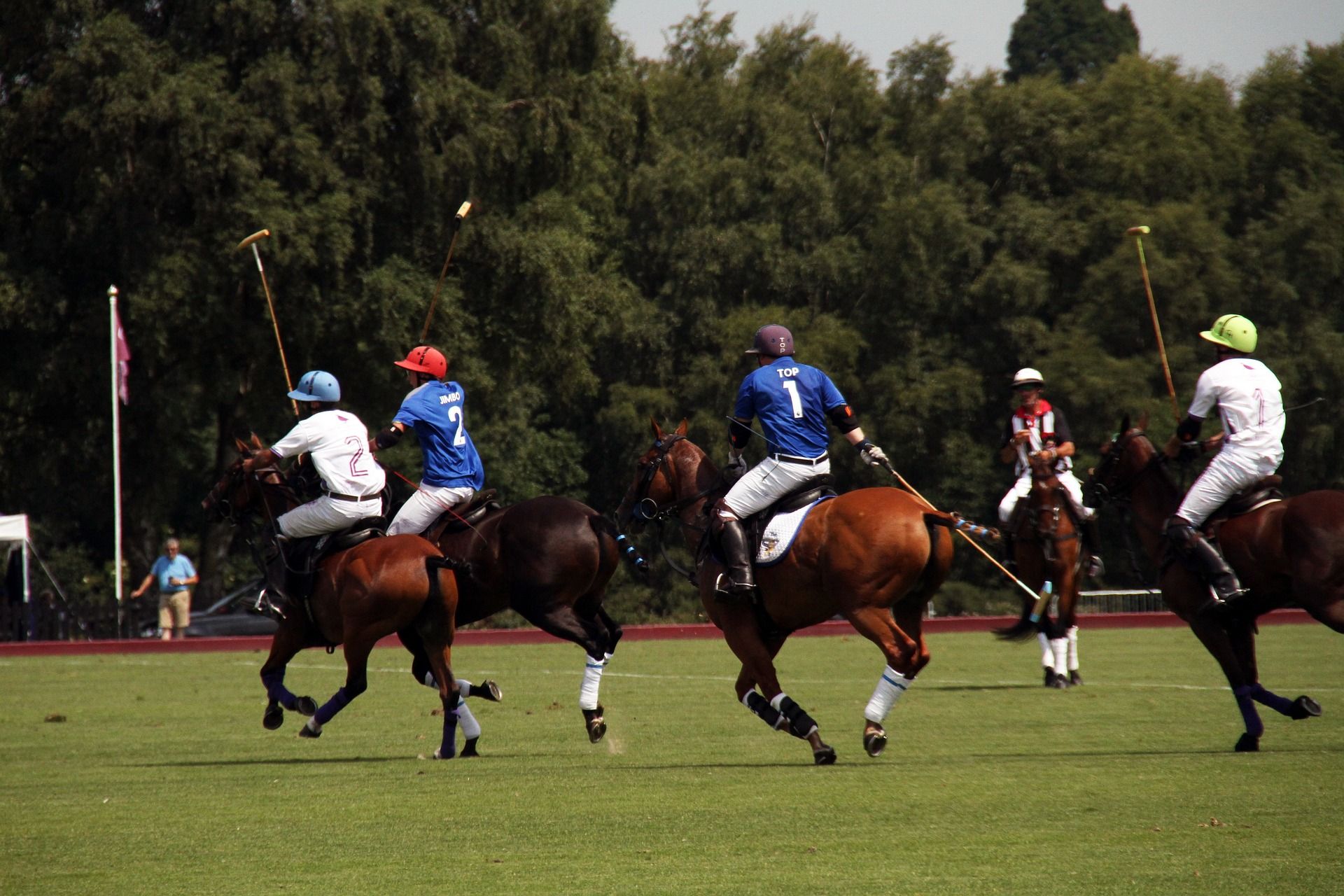 equestrians playing a game of polo on the field