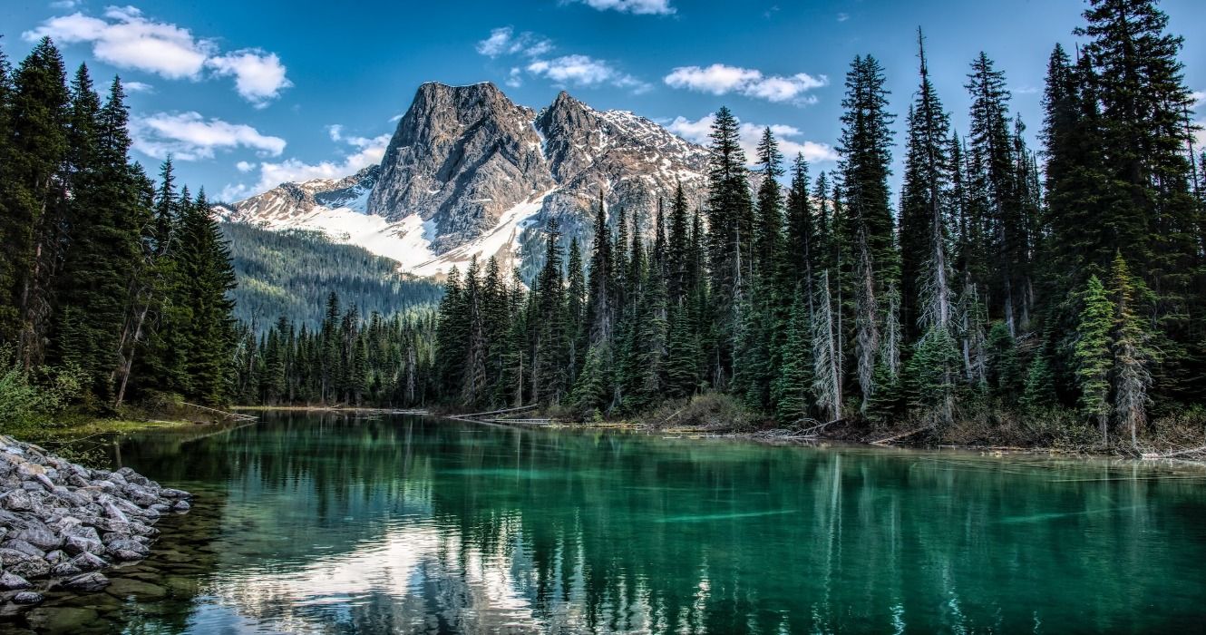 Canadian scenery in British Columbia, Canada, with beautiful blue rivers, green forests, and snowy mountains