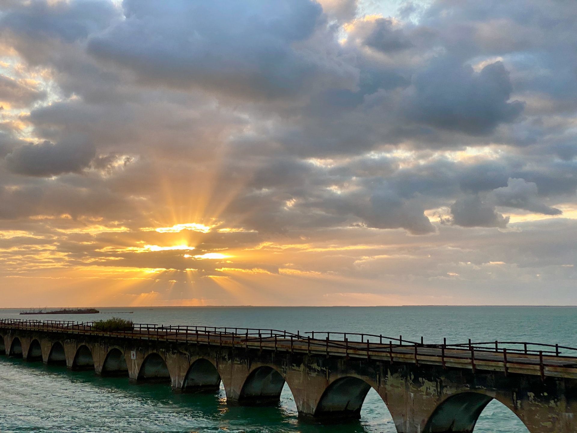 The Seven Mile bridge along the Overseas Highway in Florida with a sea view and a sunset 