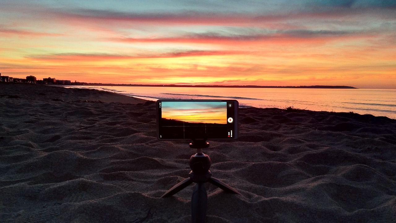 Person recording the sunrise at Old Orchard Beach