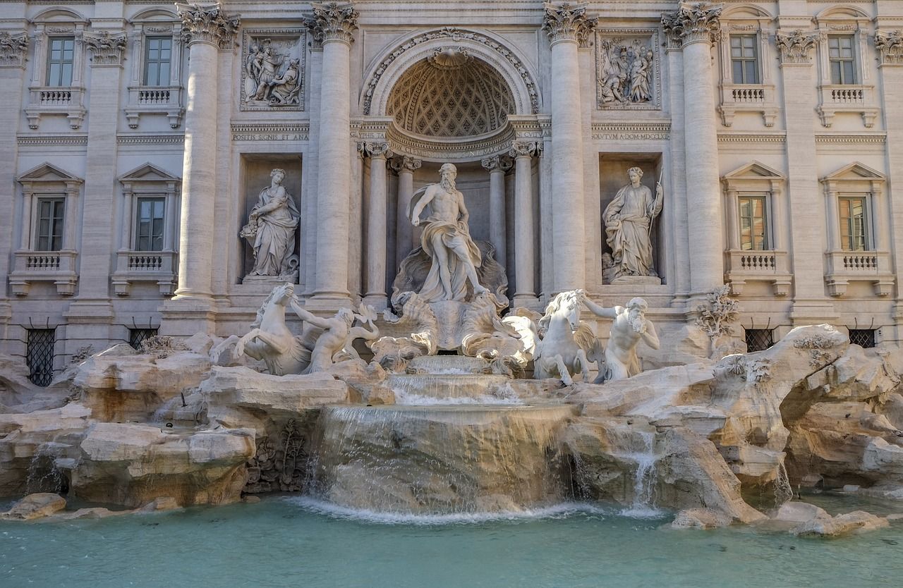 Front view of the Trevi fountain with beautiful blue water
