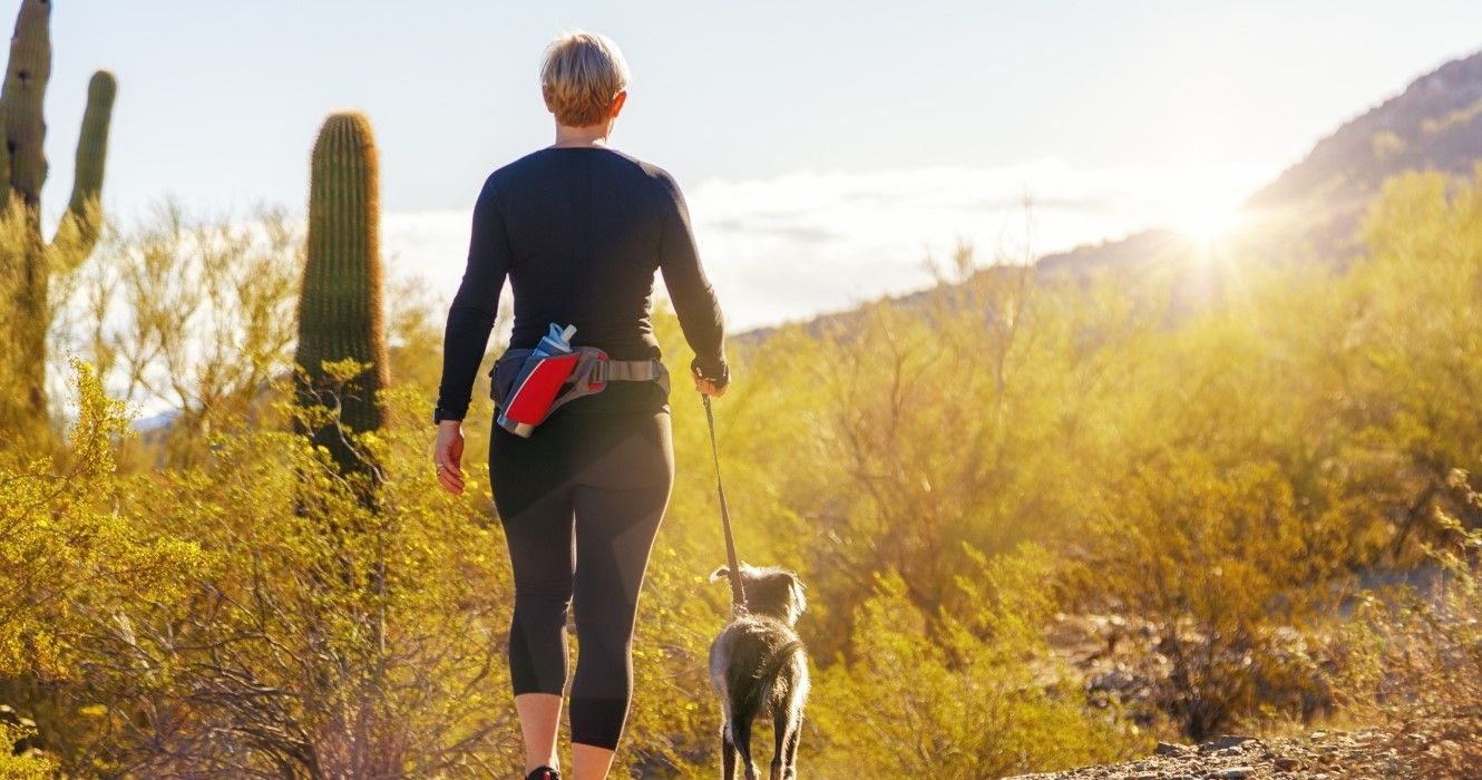 Woman with a dog hiking in Phoenix, Arizona