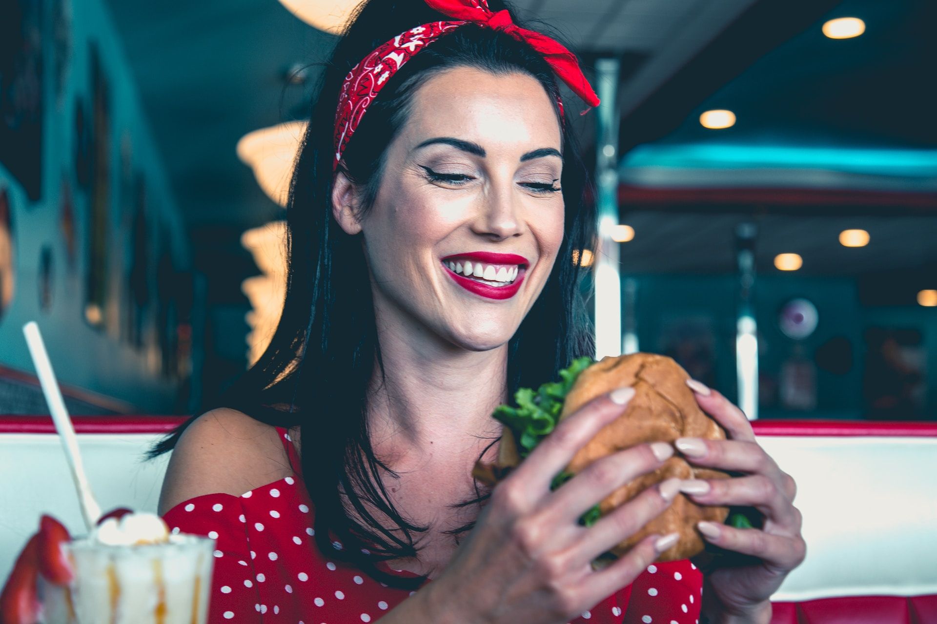 A woman eats a burger in Agawam Diner in Rowley in Massachusetts