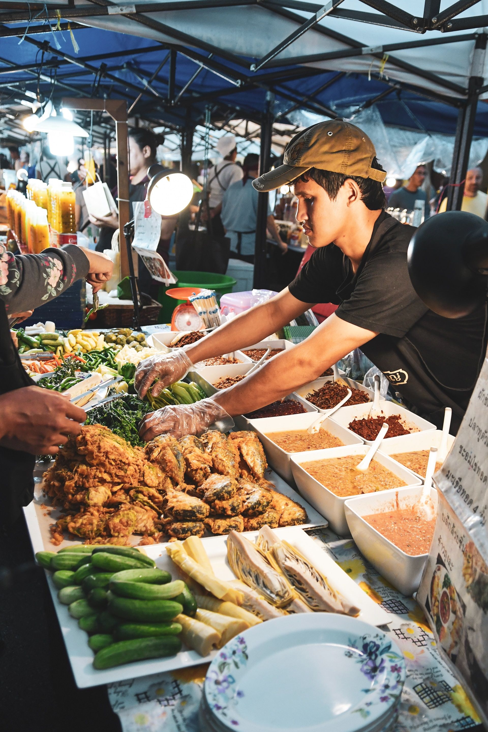 Man selling food at a street food market in Phuket