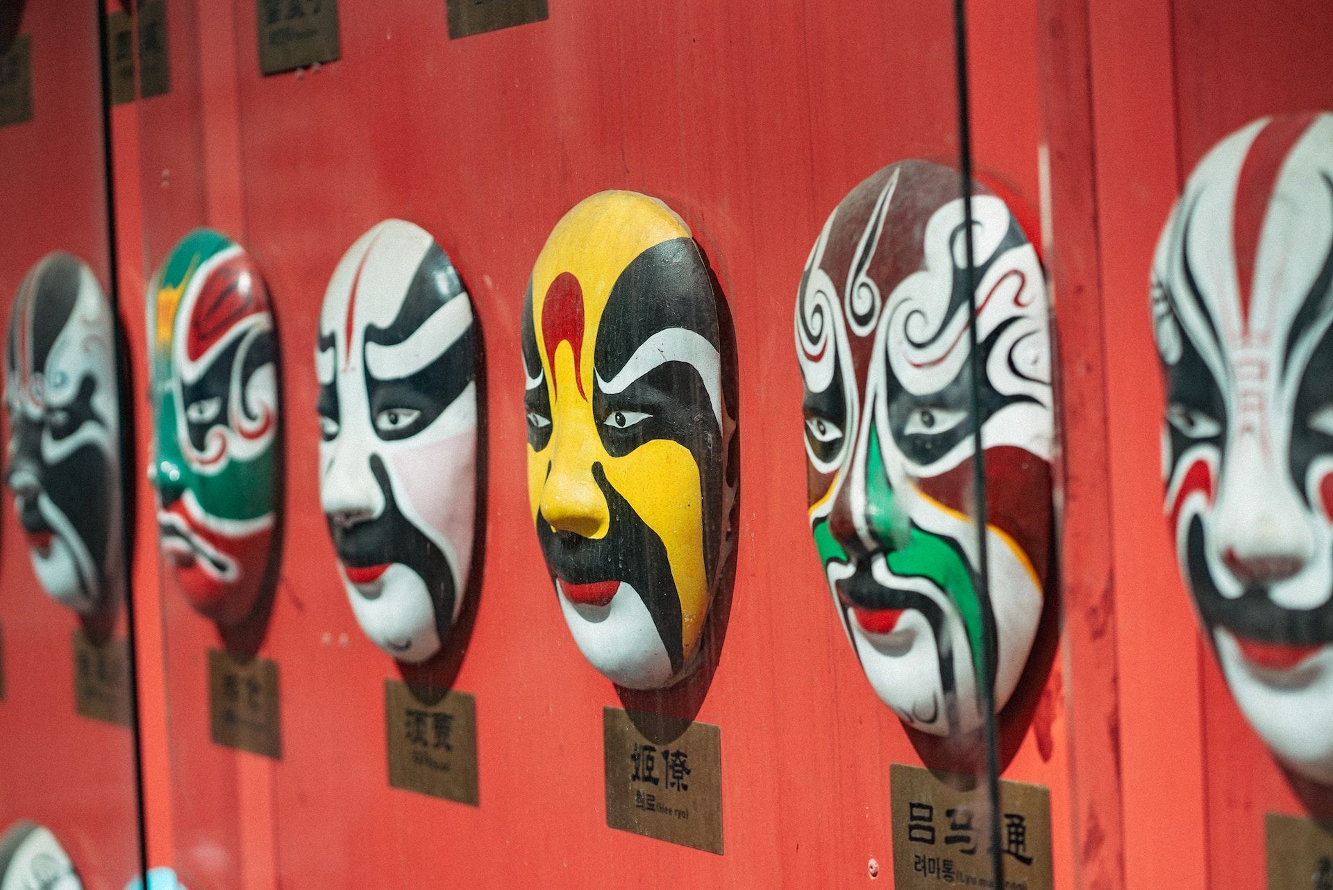 Kabuki face masks on a wall