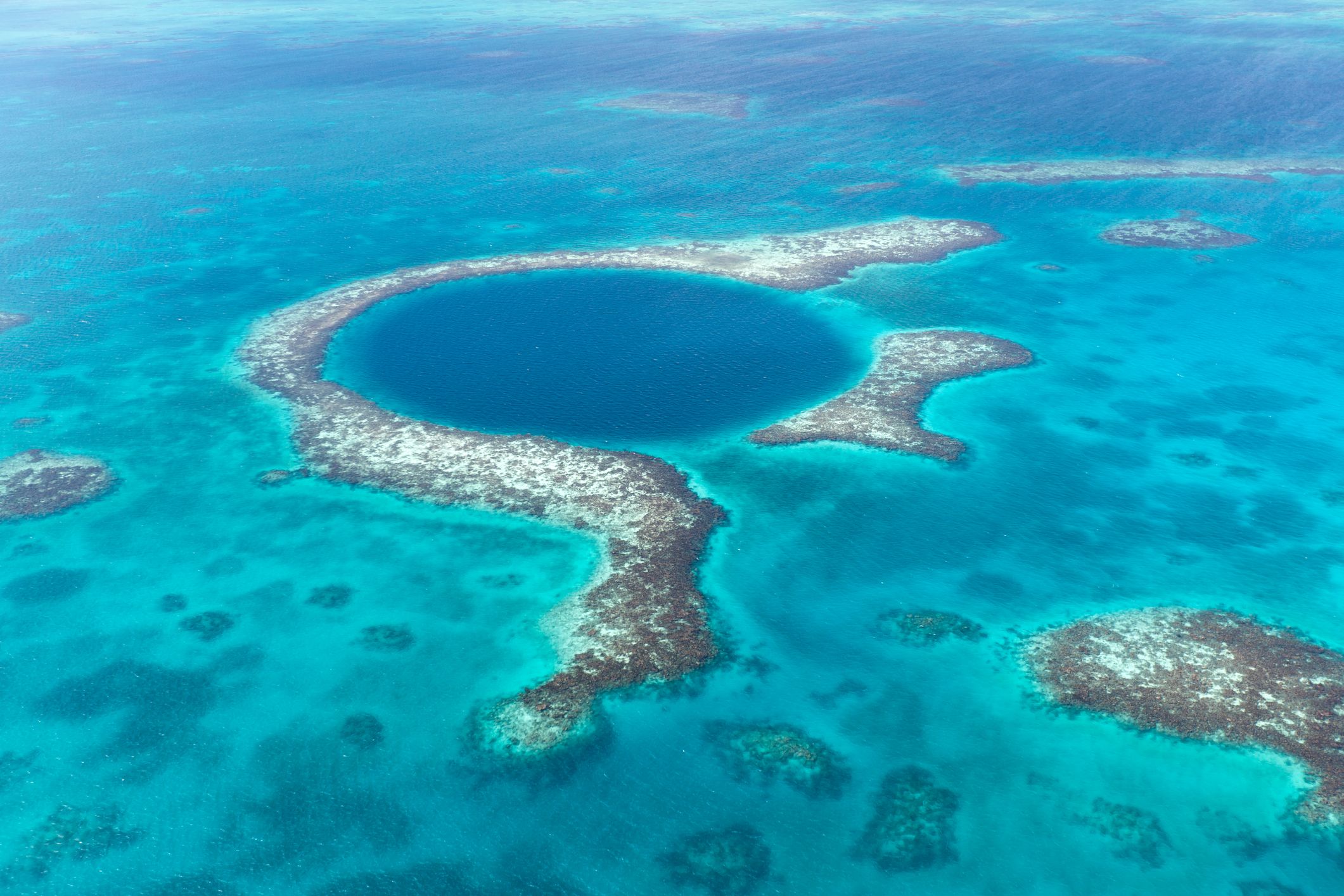 An aerial view of the coral reef and deep cave that make up the Belize Blue Hole