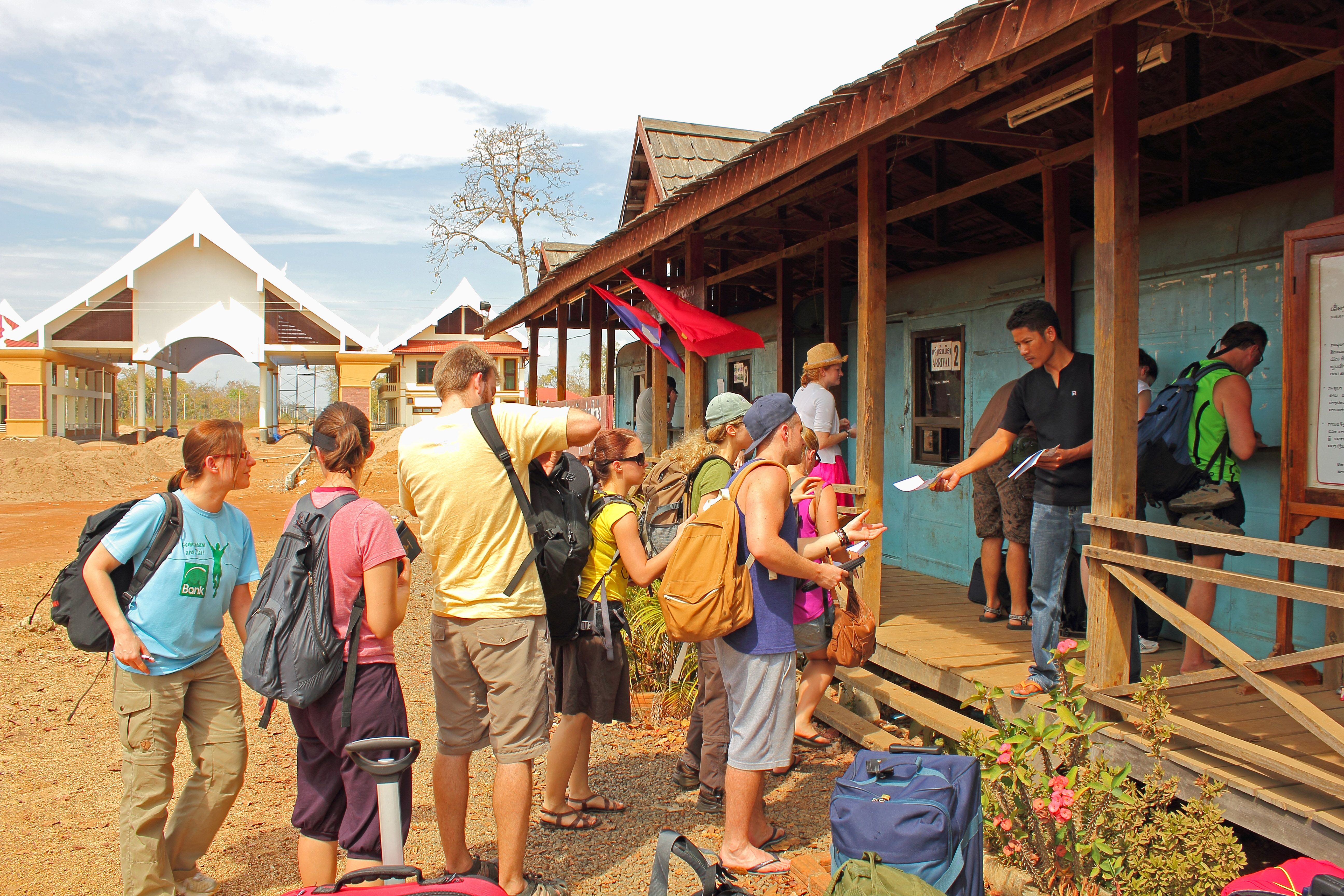 Tourists receiving their visas at the border between Cambodia and Laos