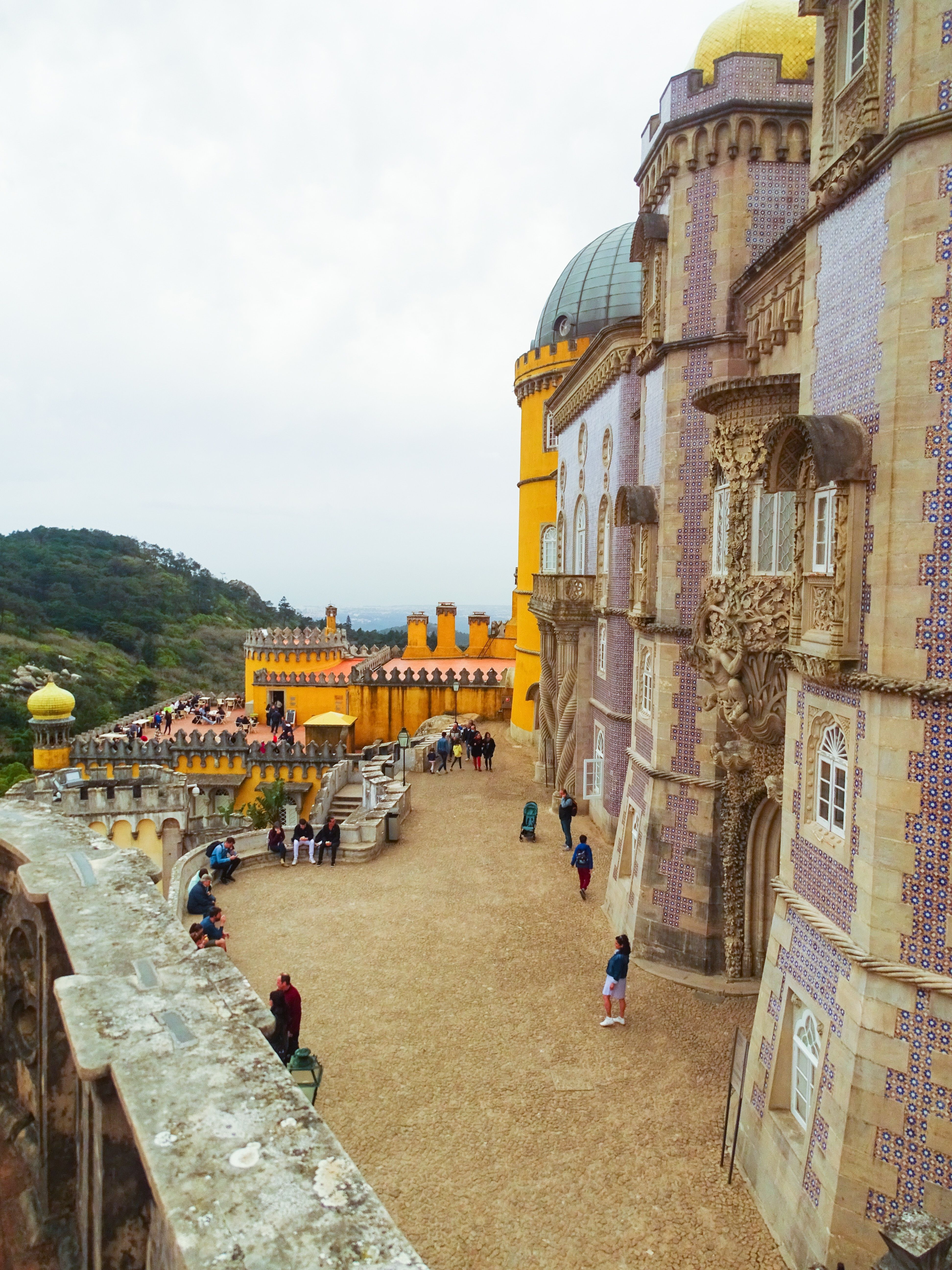 Tourists walk around colorful palace 