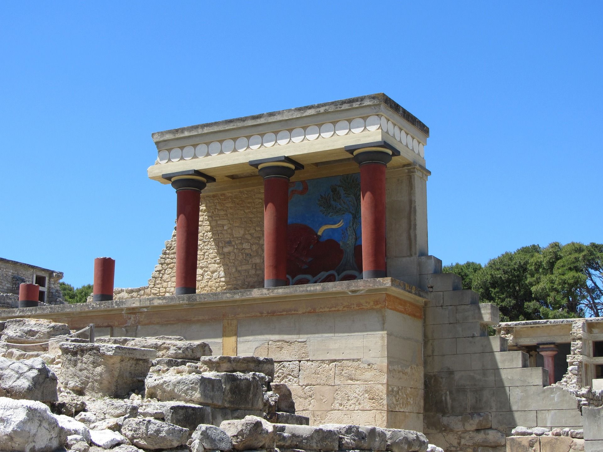 T beautiful red pillars of Knossos against the blue of the sky, Crete, Greece