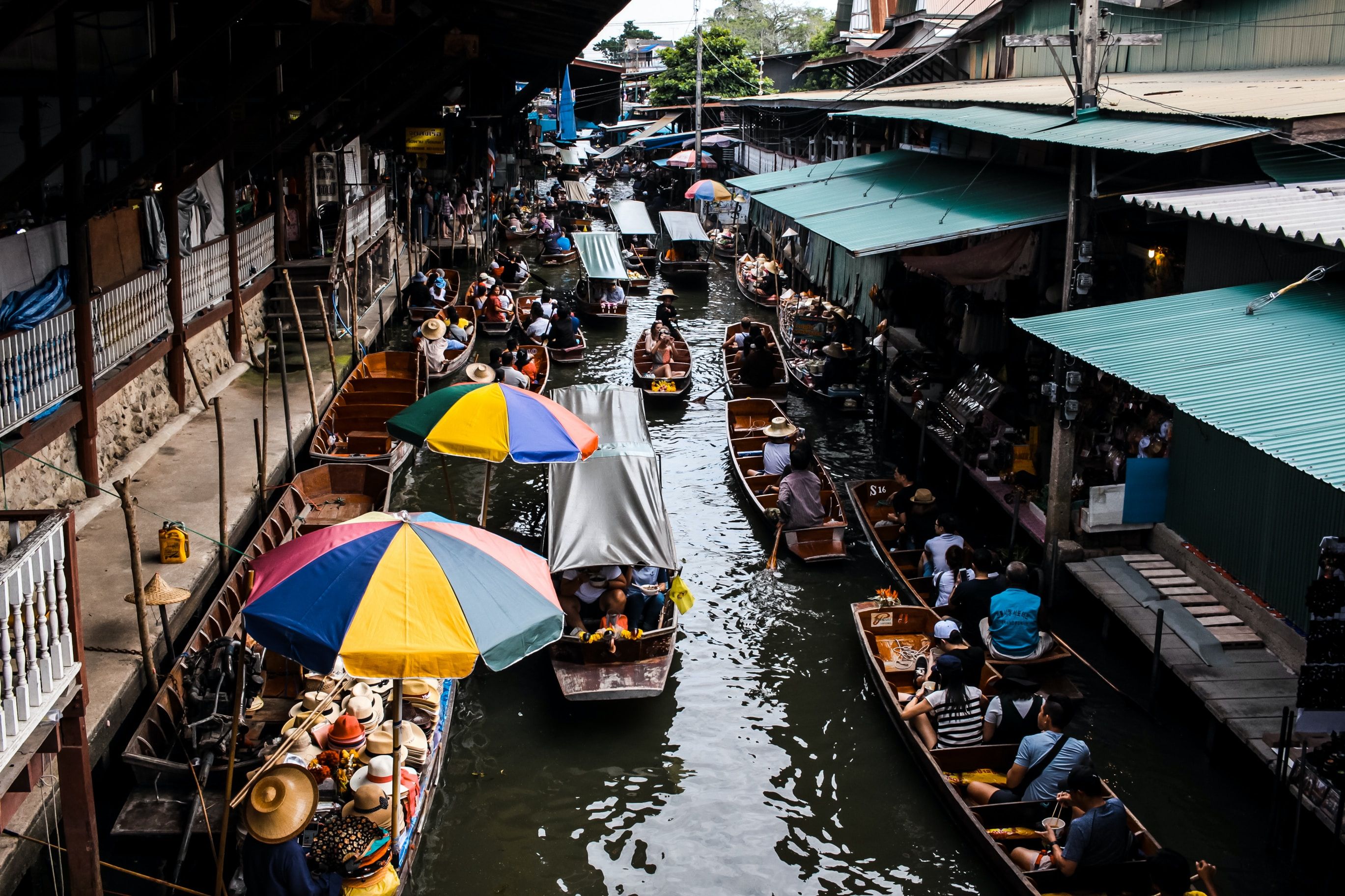 Boats in the water with umbrellas at Bangkok floating market 