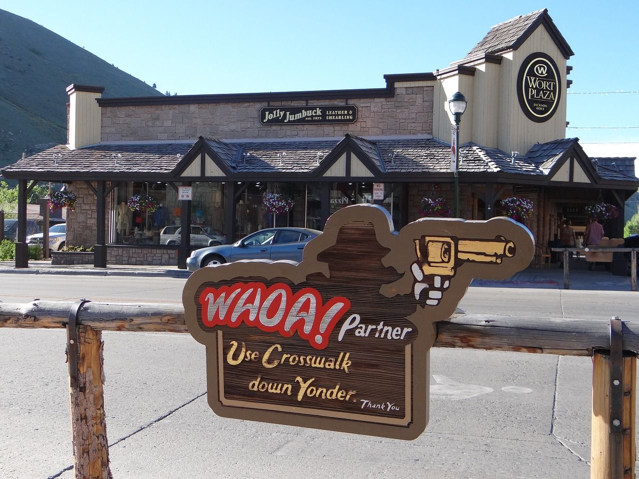 A wooden street sign in front of a restaurant in Jackson, Wyoming