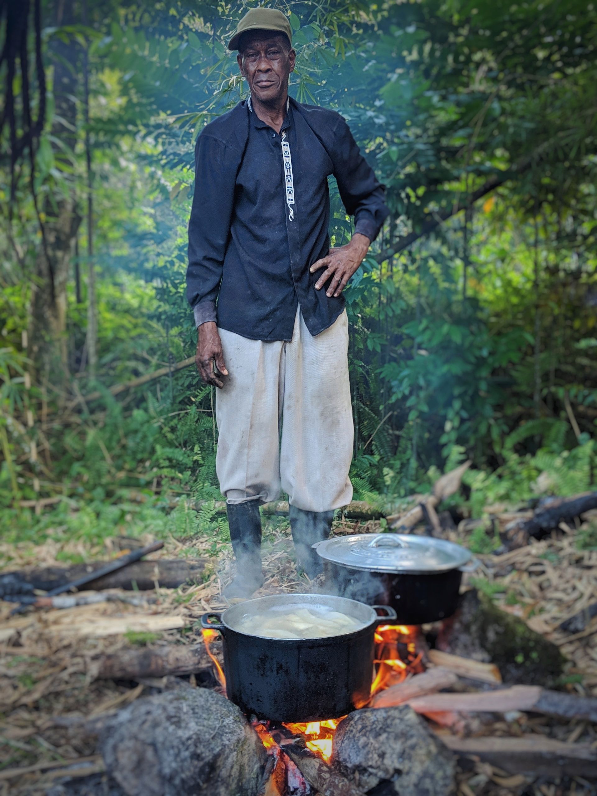 A Person Cooking On A Traditional Outdoor Open Fire In Jamaica
