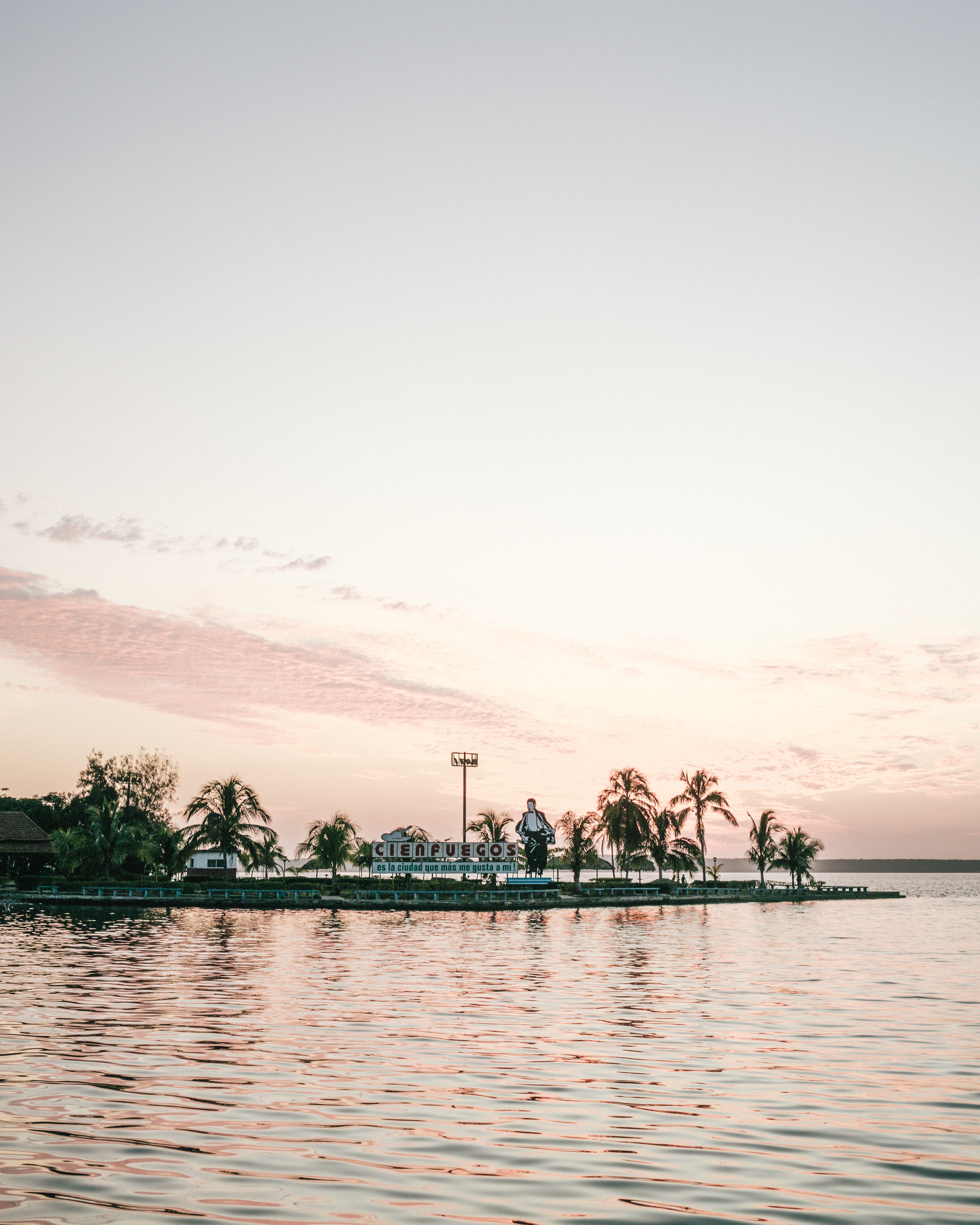 A person standing on a dock near a body of water in Cienfuegos