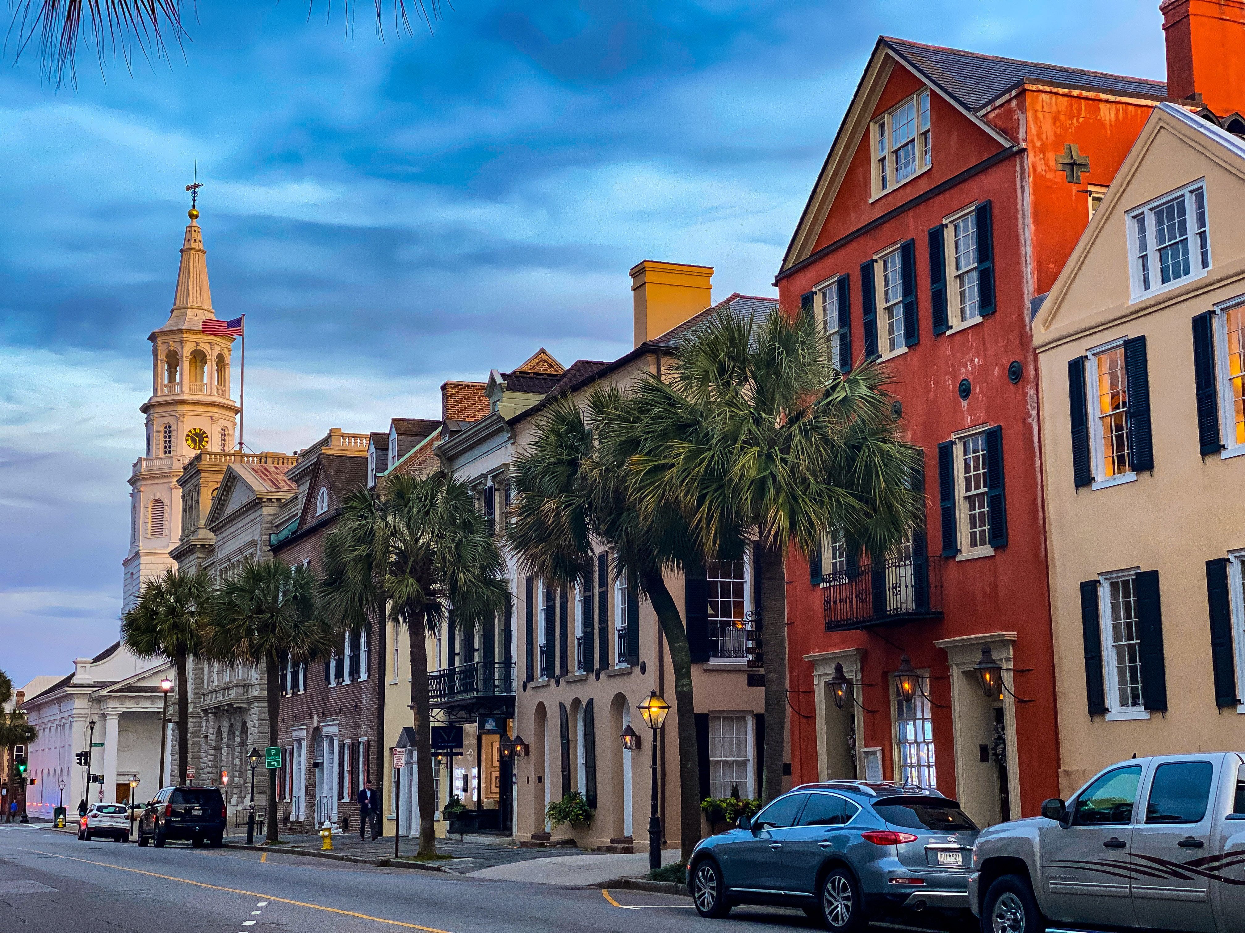 Charleston street lined with colorful homes and palm trees 