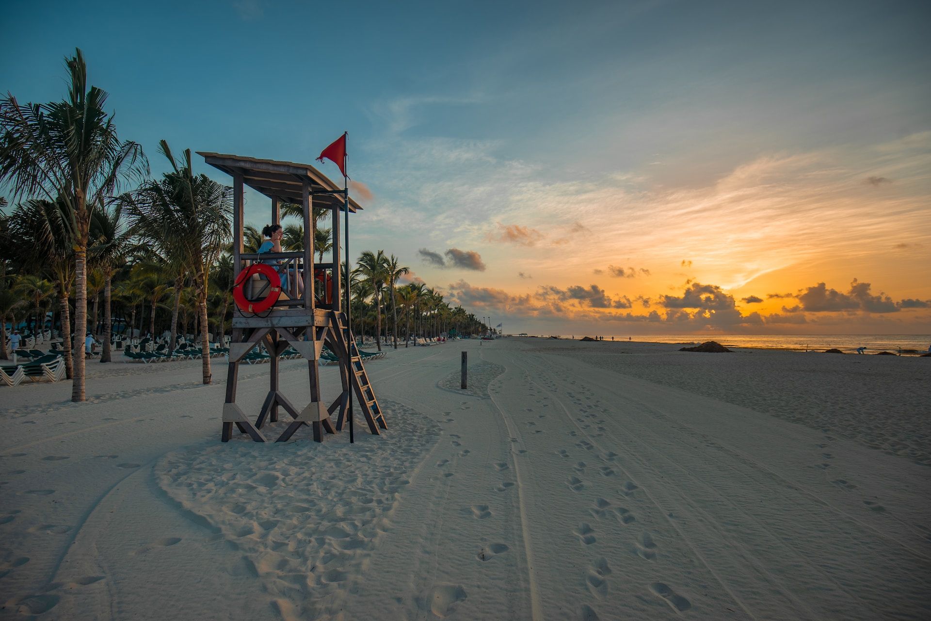 Lifeguard on a tower on the beach in Playa del Carmen at sunset