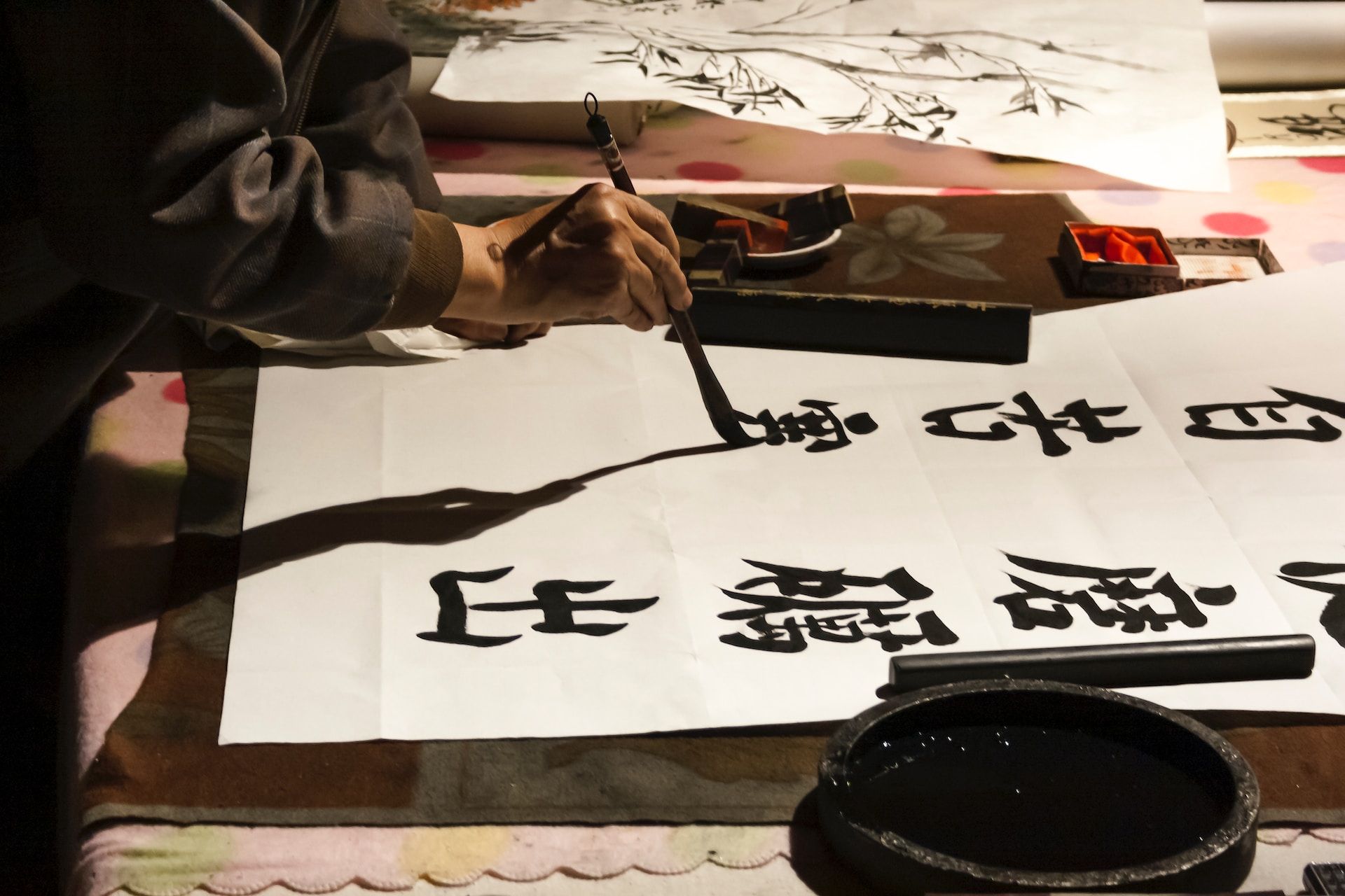 Person writing Japanese calligraphy