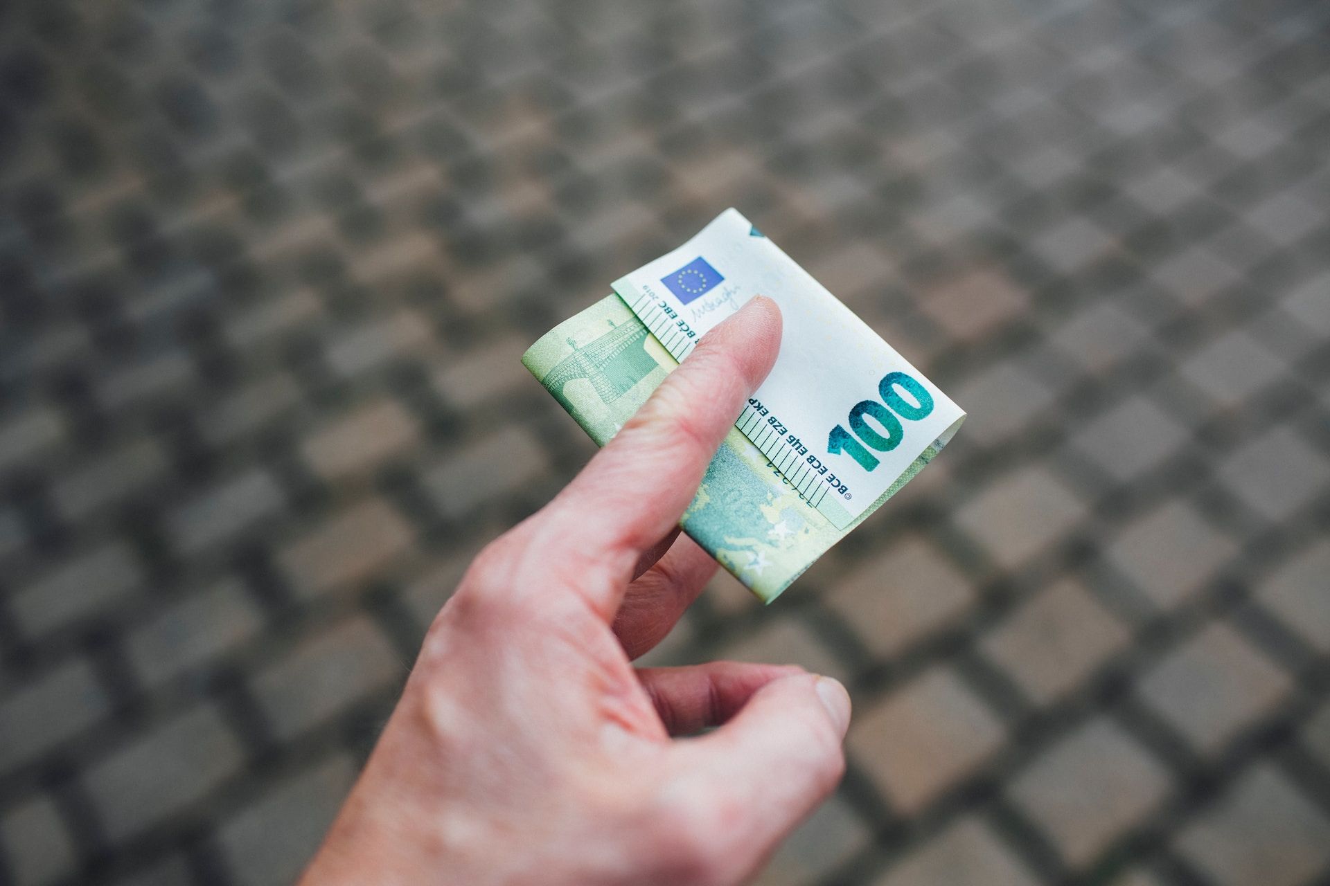 Person holding a 100 euro bill