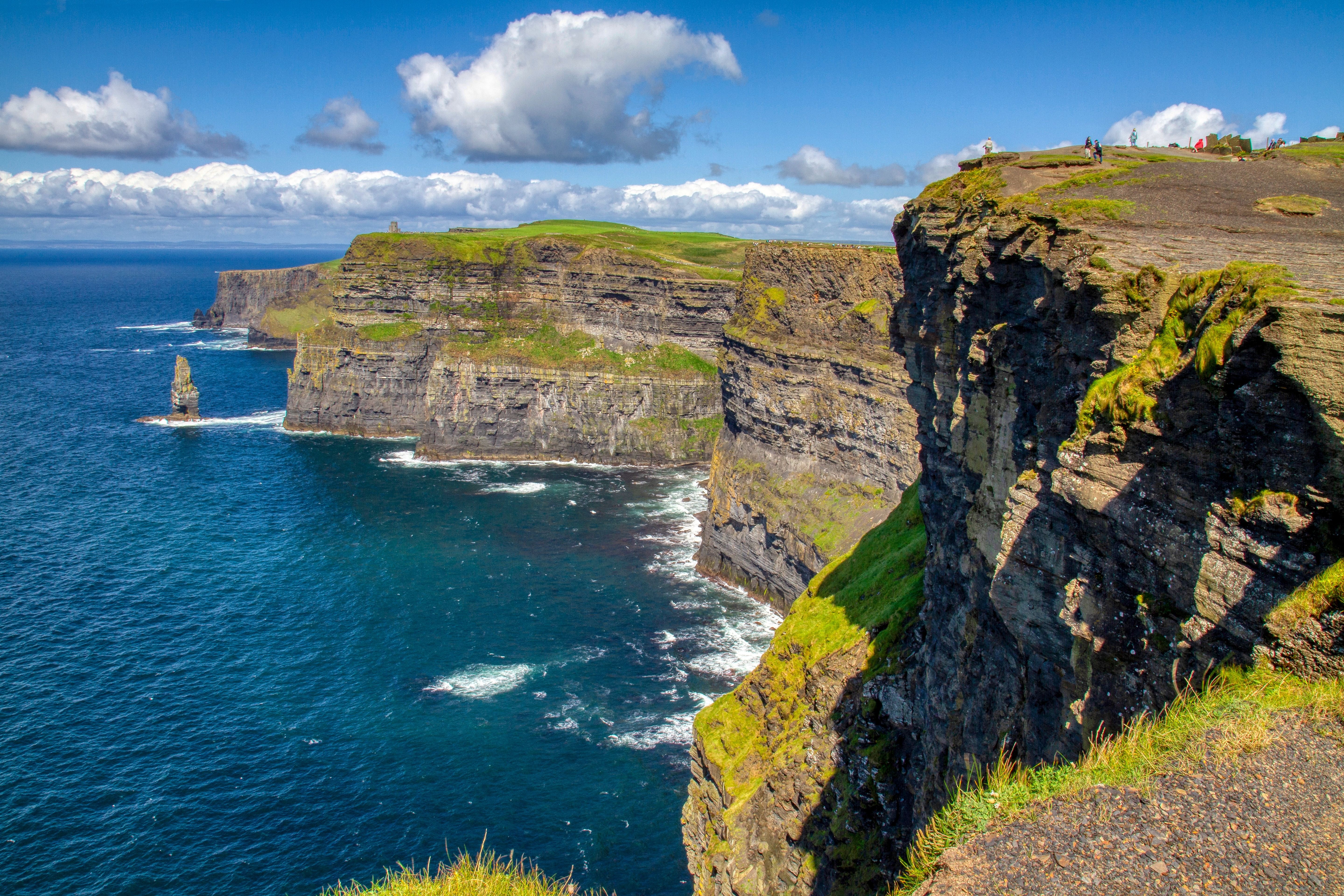 The dramatic gray cliffs Cliffs of Moher in Ireland overlooking the ocean 