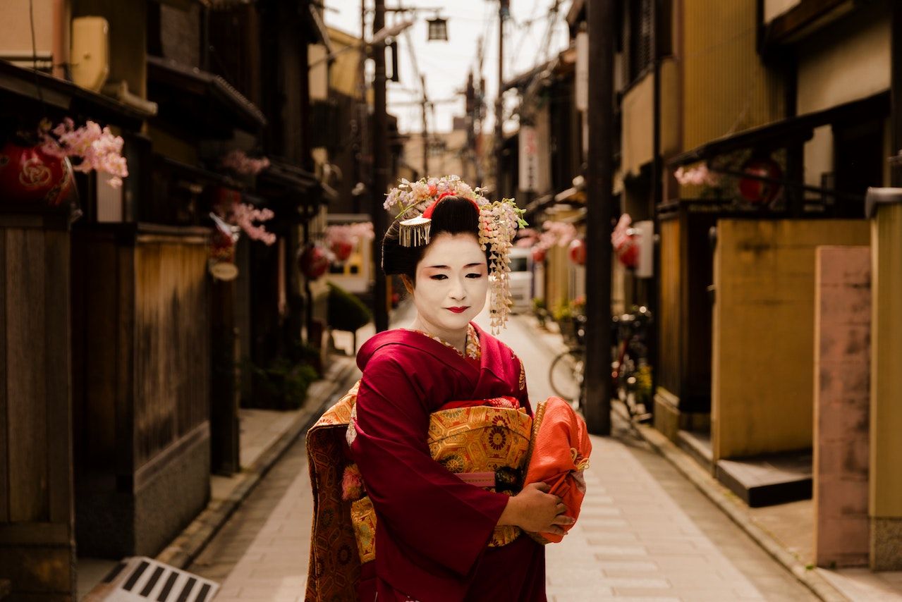 A geisha standing on the street