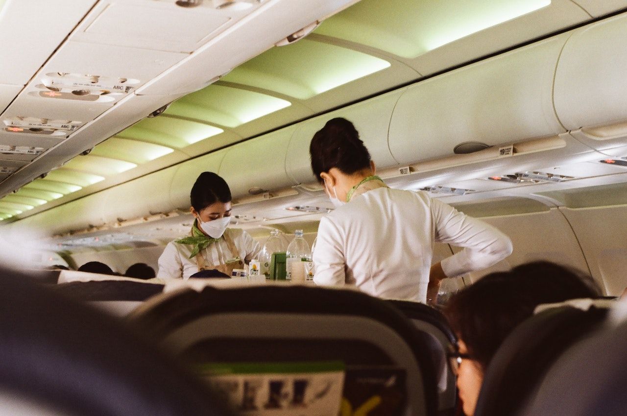 Two flight attendants with a drinks cart