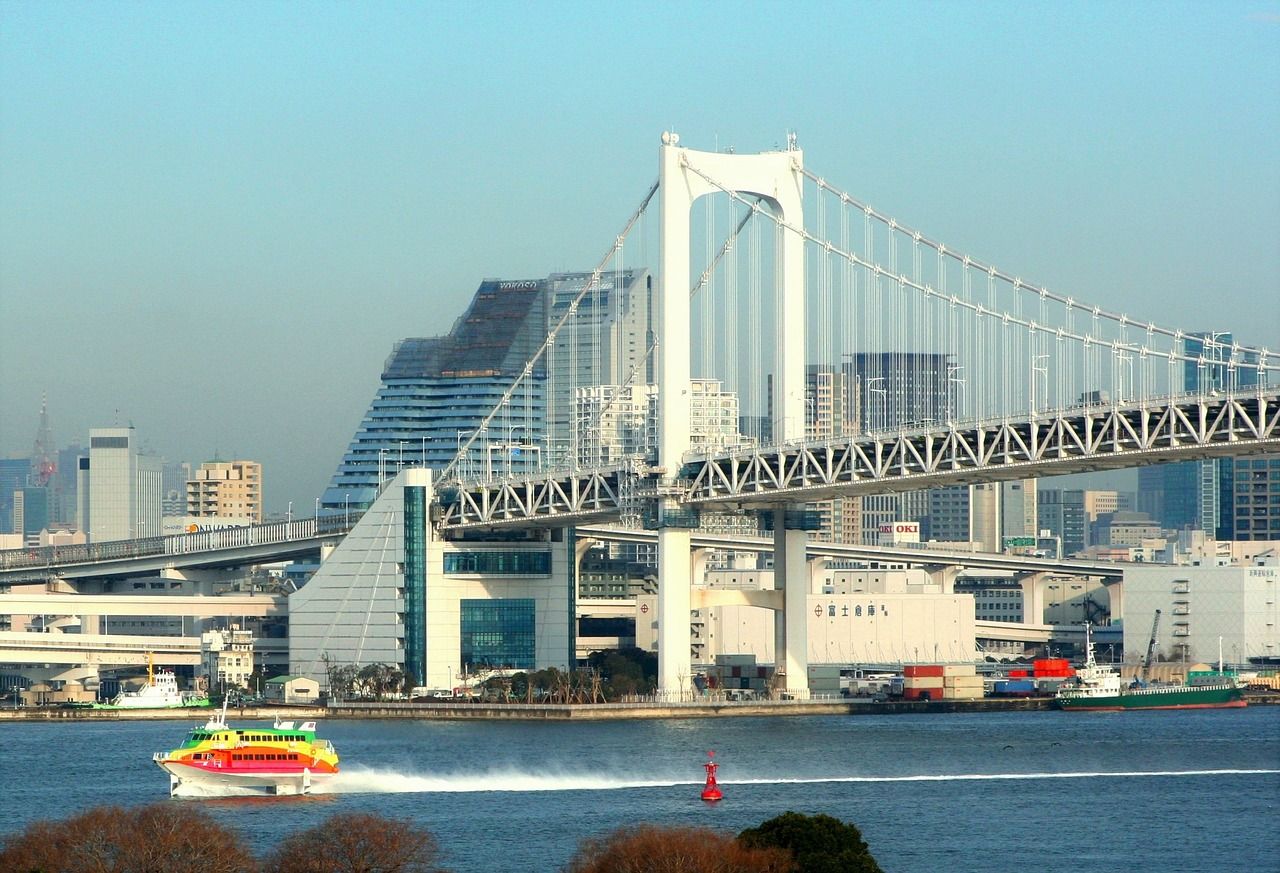 Rainbow Bridge and a colored boat on Tokyo Bay 