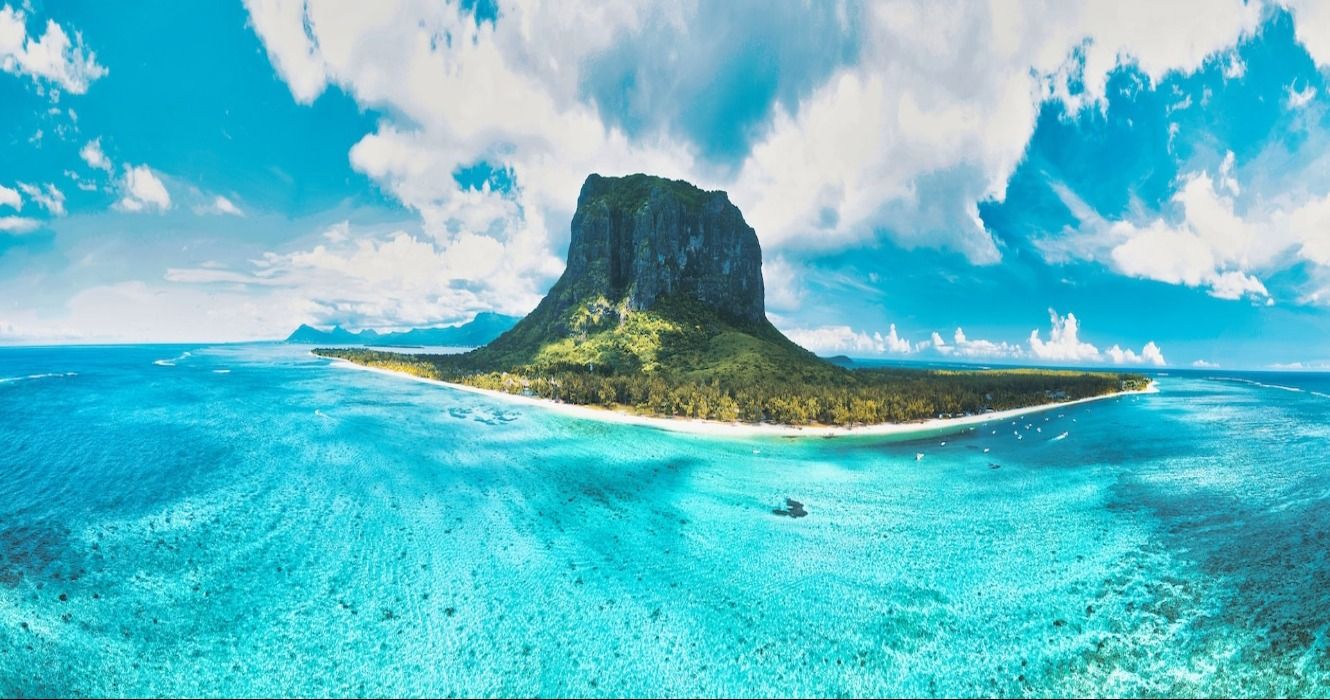 Turquoise blue ocean and a green forest-covered island in Le Morne, Mauritius