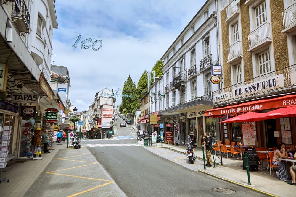 Cafés and shops at Boulevard de la Grotte, Lourdes, France