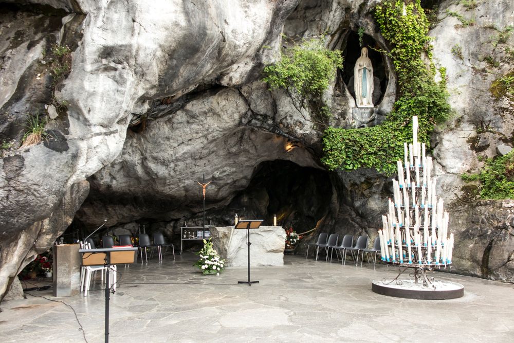 A ceremony about to take place outside of a grotto in Lourdes