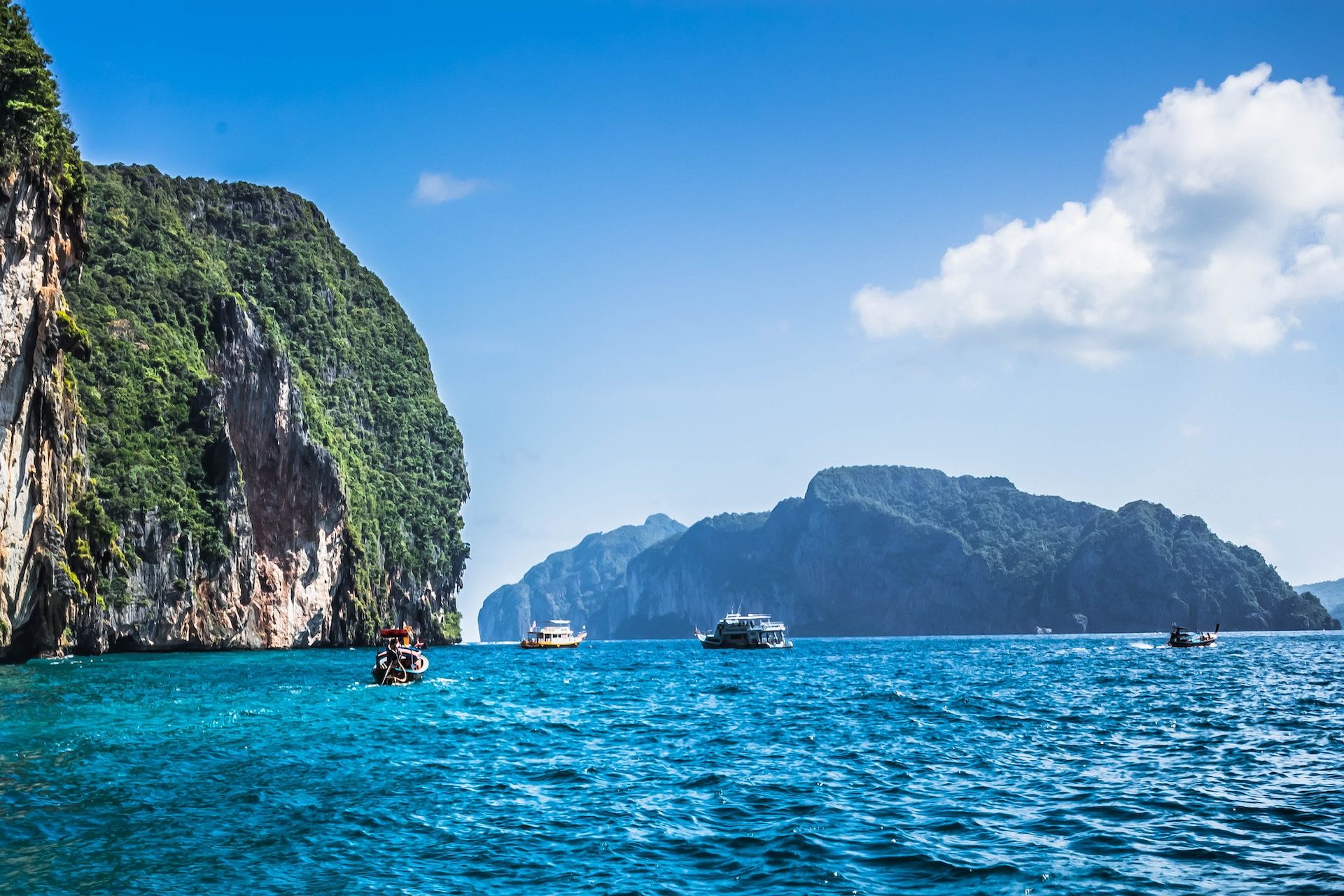 Boats near a cliffside in Phuket, Thailand