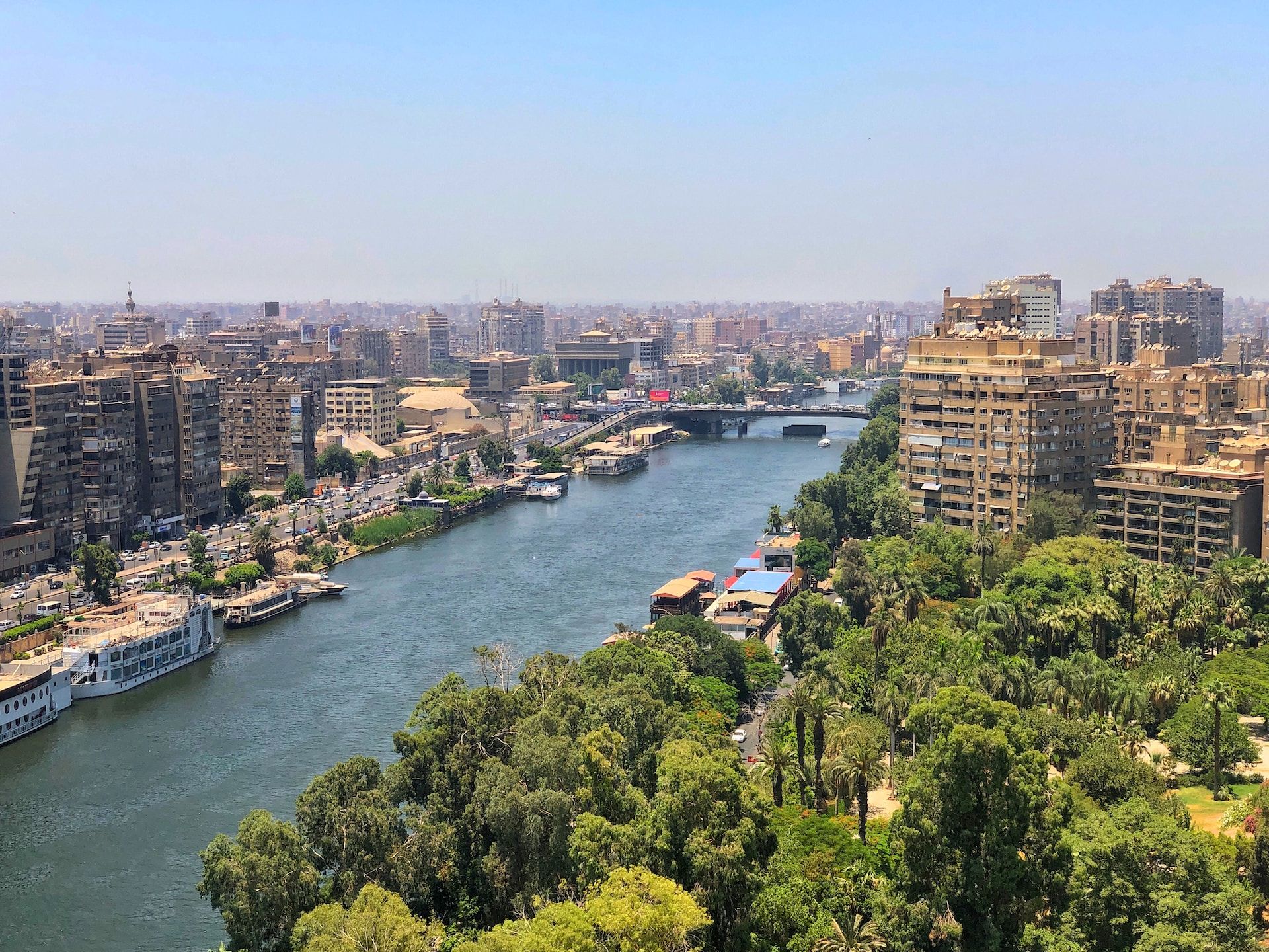 A stunning aerial view of the Nile River with the Zamalek District to the right and the Agouza District to the left.