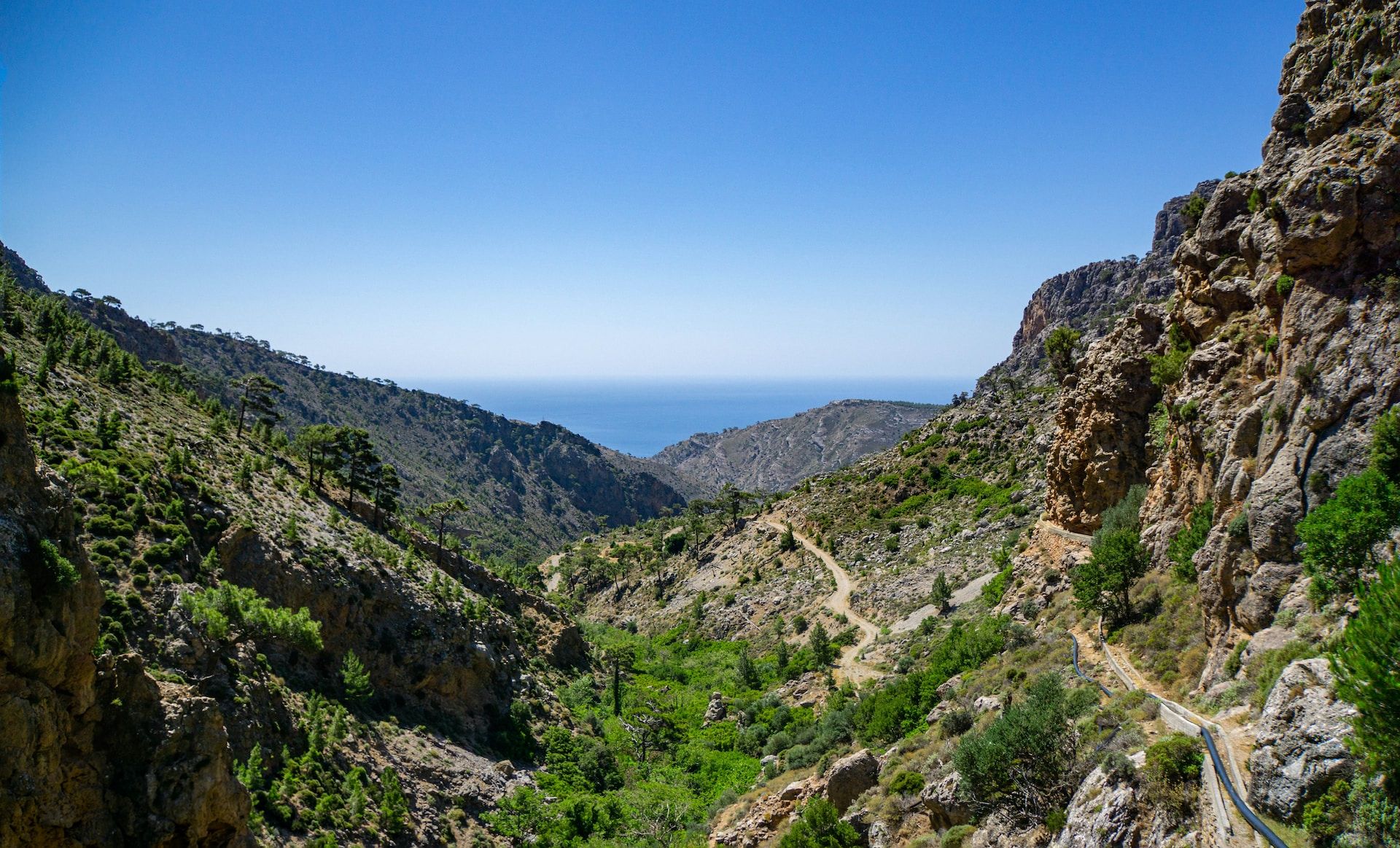 Mountains in Crete with a bright blue sky and a deep blue sea