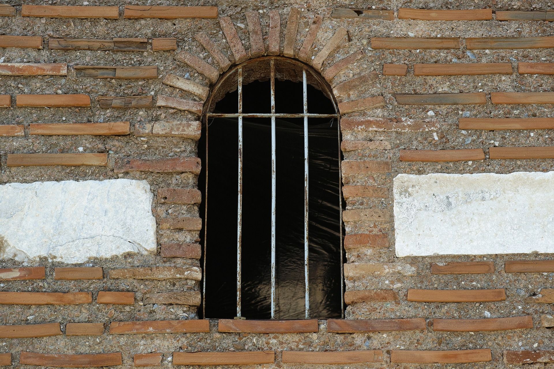 Barred window in an old prison dungeon