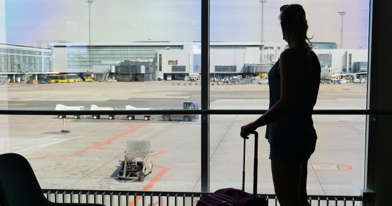 Woman staring at the airport runway
