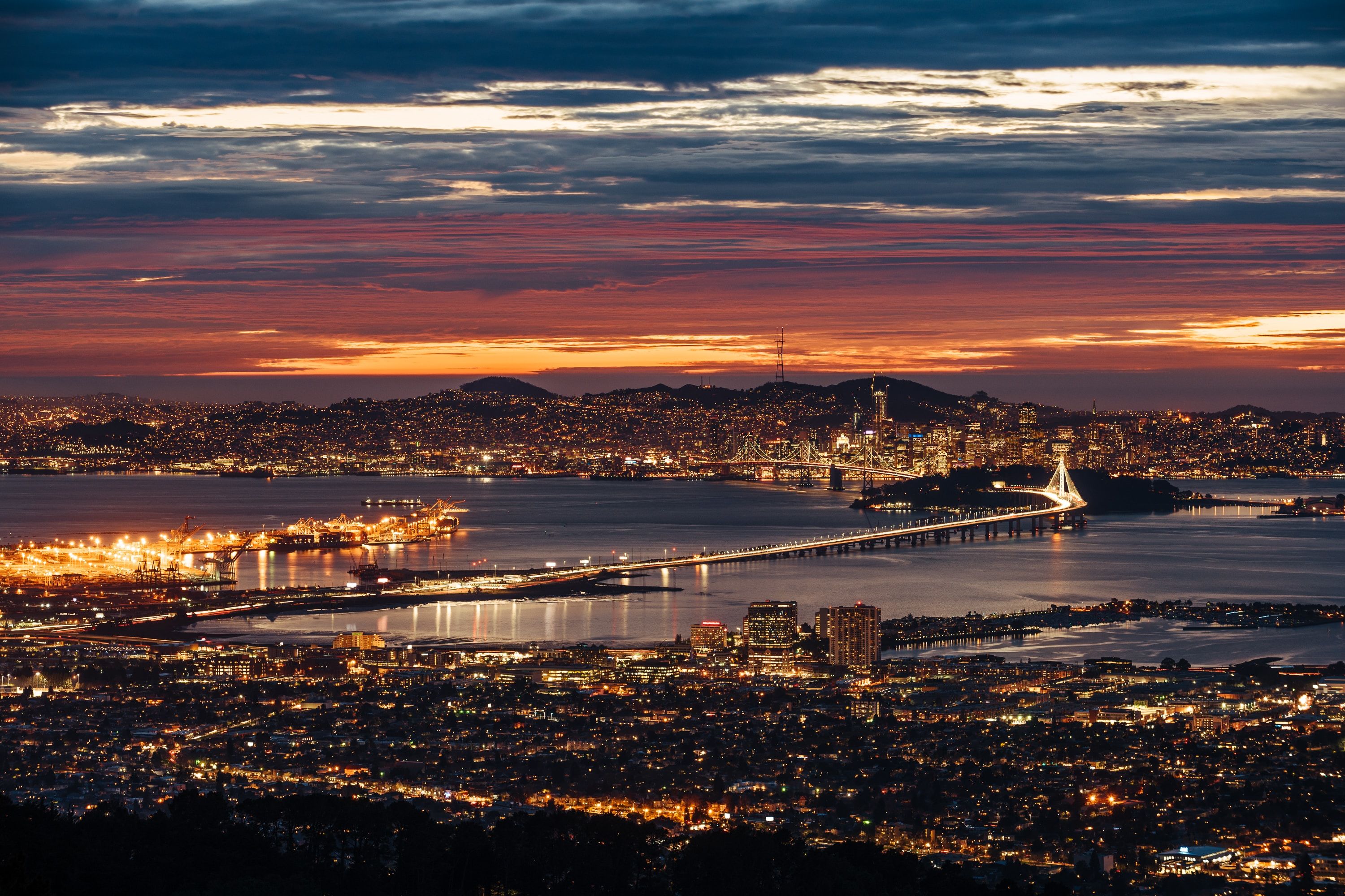 Aerial view of lighted city buildings near river in Bay Area, San Francisco 