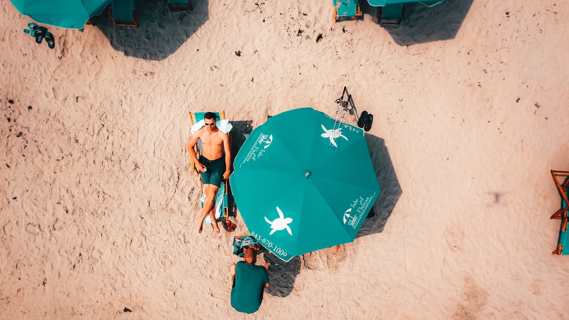 Tourists relaxing under a beach umbrella on Isle of Palms
