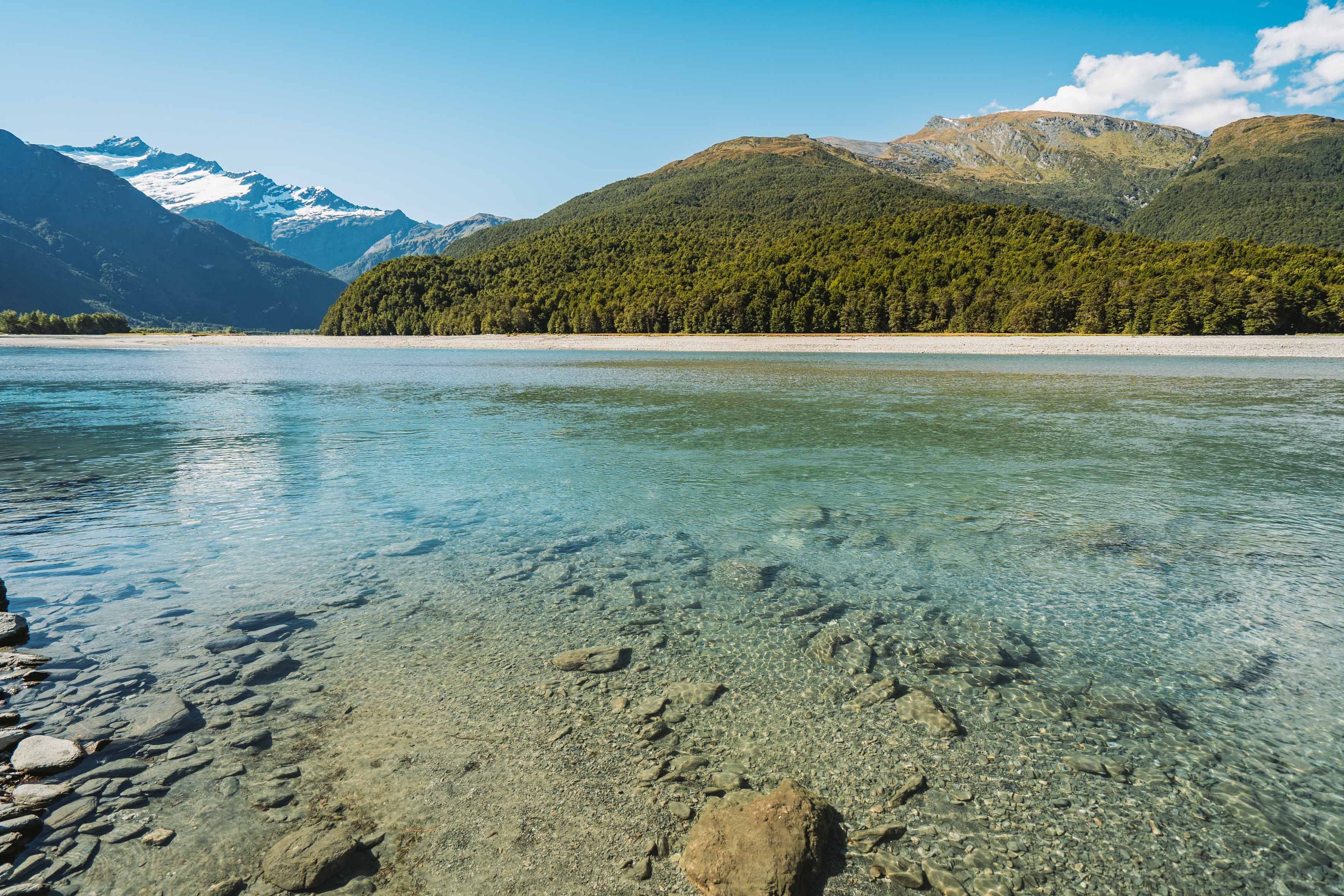 A crystal clear Mount Aspiring with mountains and a blue sky in the background, New Zealand