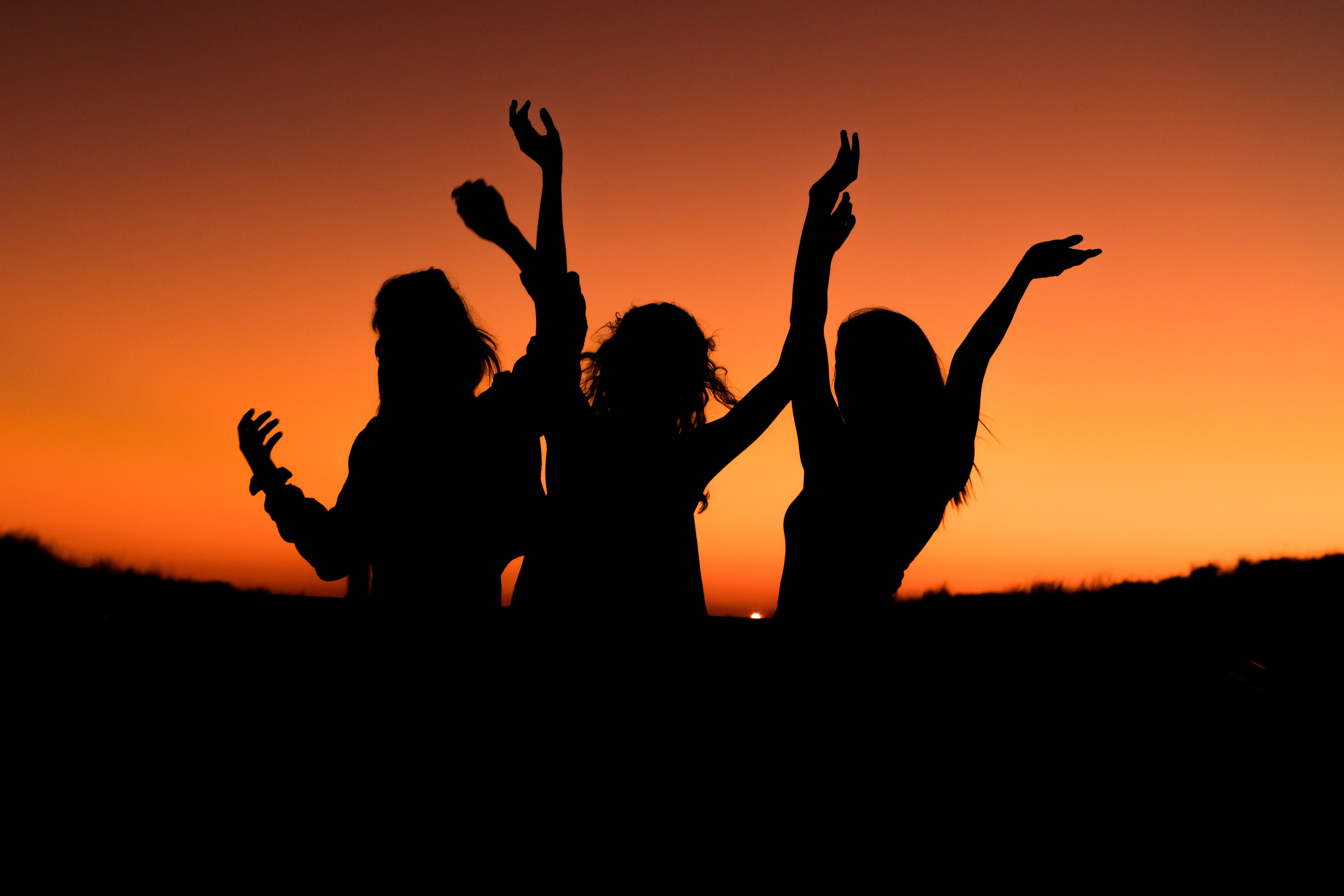 Silhouettes of three women at sunset 