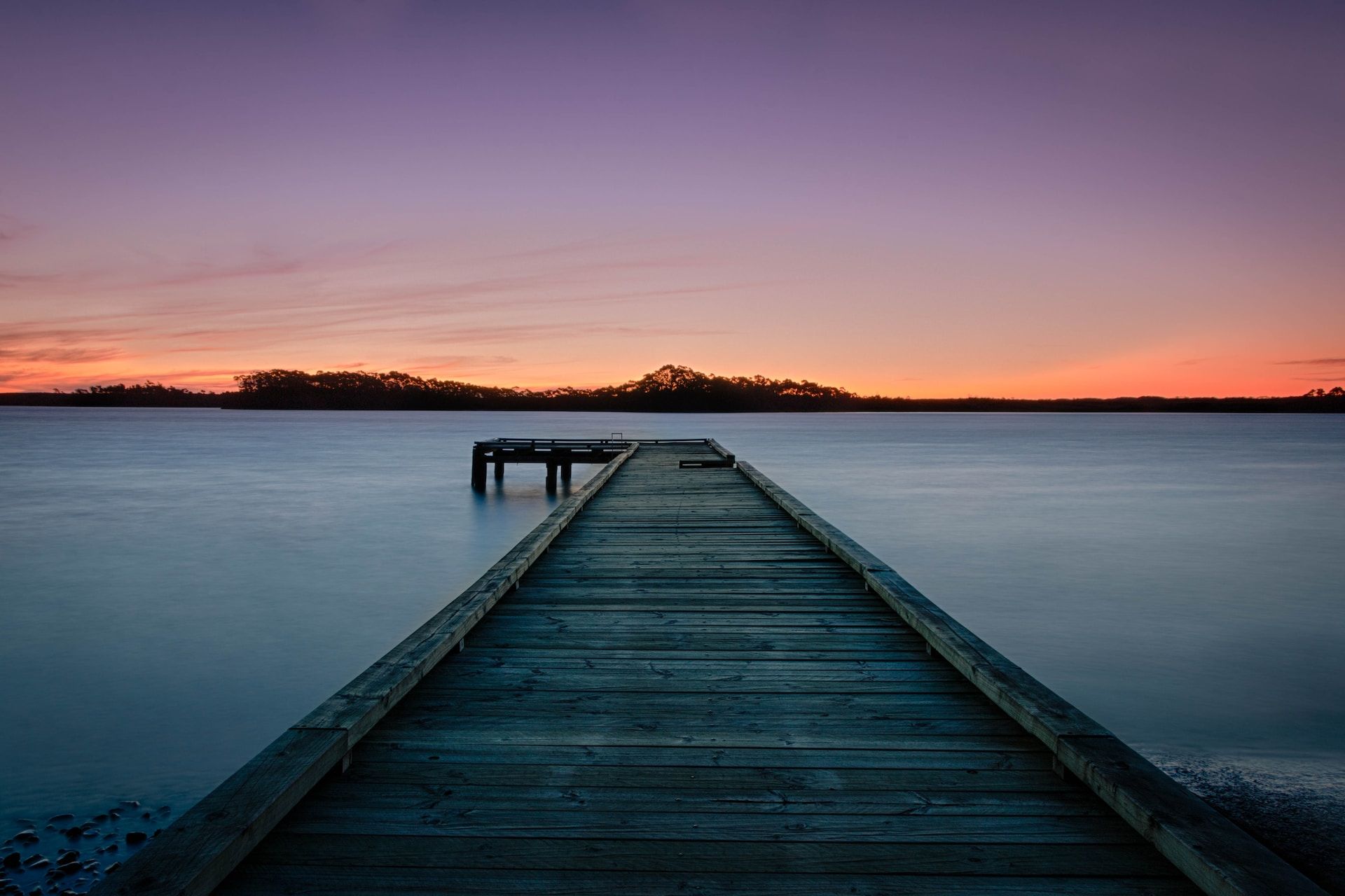 Dock over the water at sunset in Strahan, Tasmania