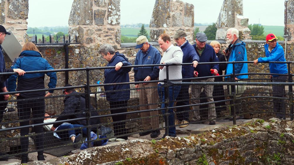 People lined up to kiss the Blarney Stone at Blarney Castle