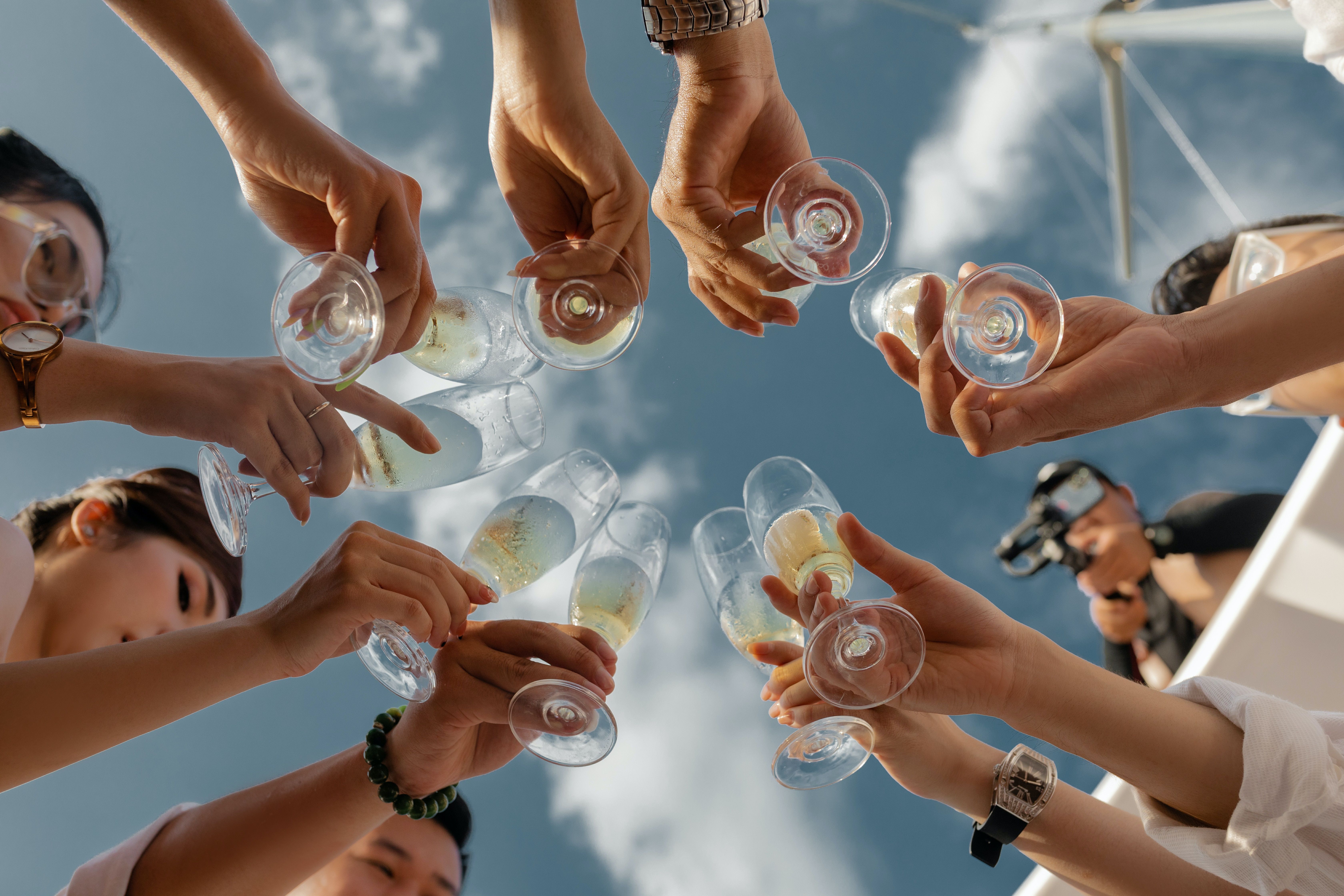 Hands holding champagne glasses 