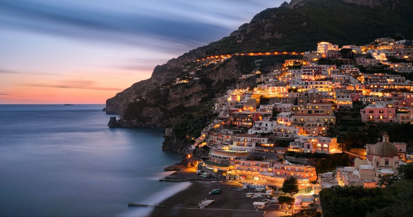 A stunning view of the Amalfi Coast overlooking the ocean at dusk after sunset, Italy