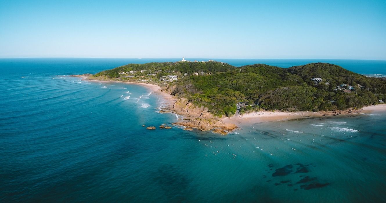 A drone photo of the coast, forests, beaches, and blue ocean of Byron Bay in New South Wales, Australia