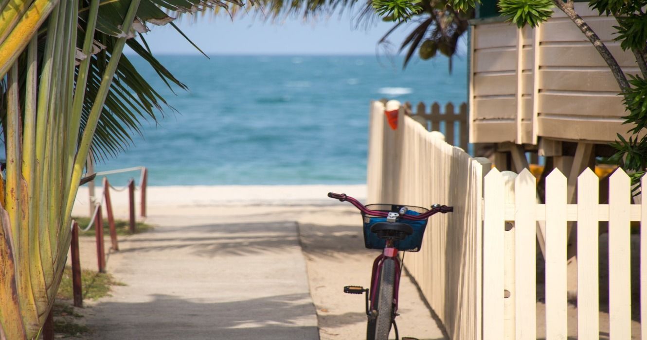 A bicycle rests against a beach house fence in Key West, Florida, USA