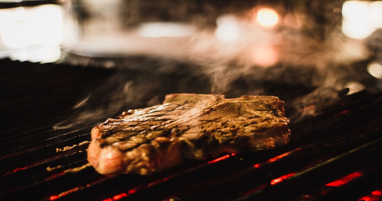 A steak cooking on a grill