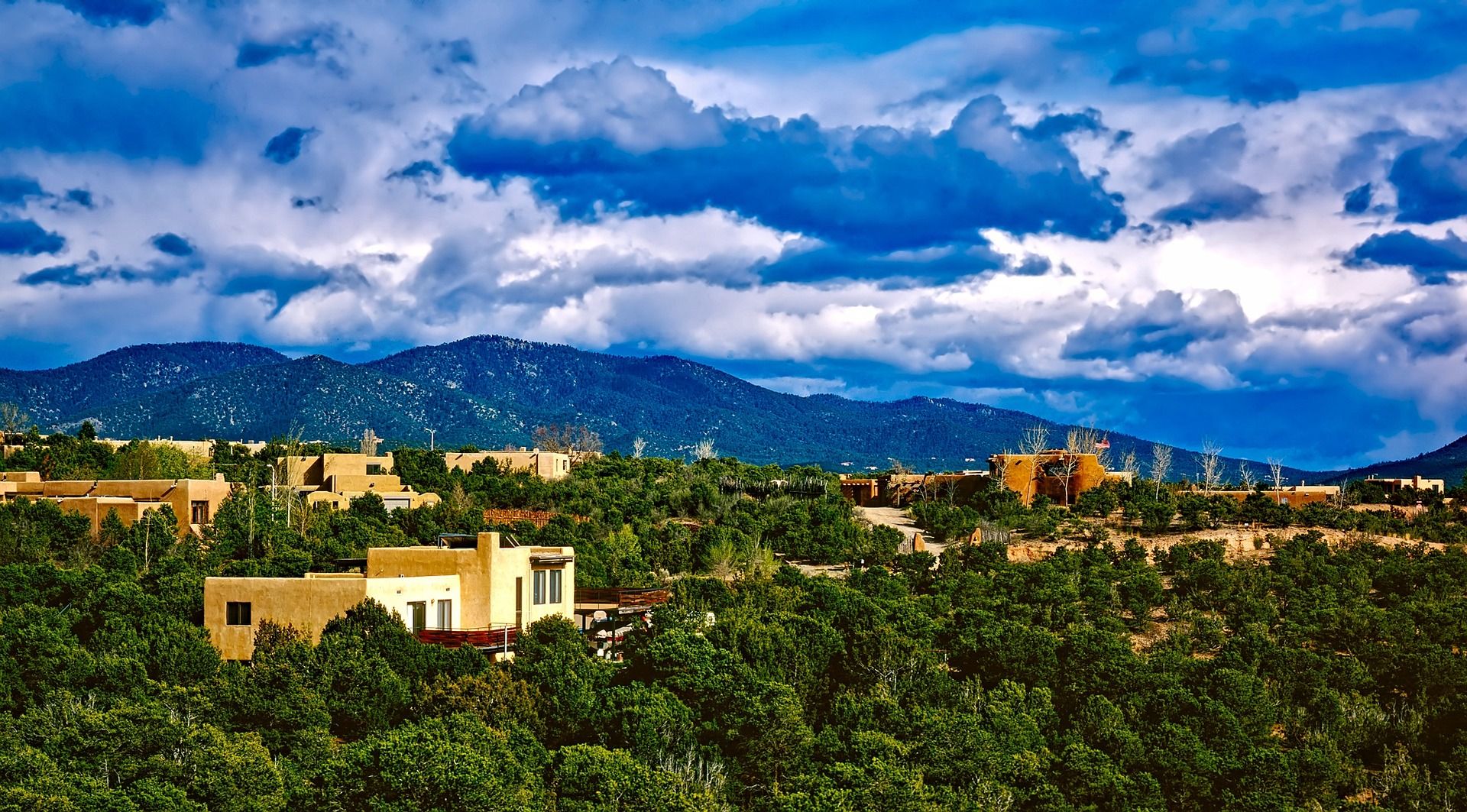Aerial view of buildings and homes nestled in the mountains in Santa Fe, New Mexico