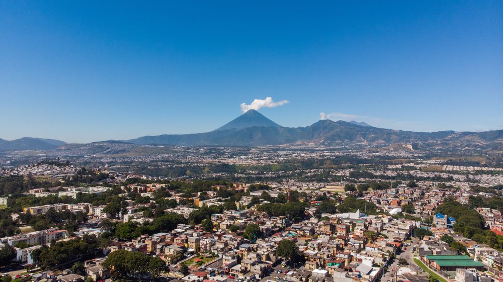 Aerial view of Guatemala City with the volcano in the distance