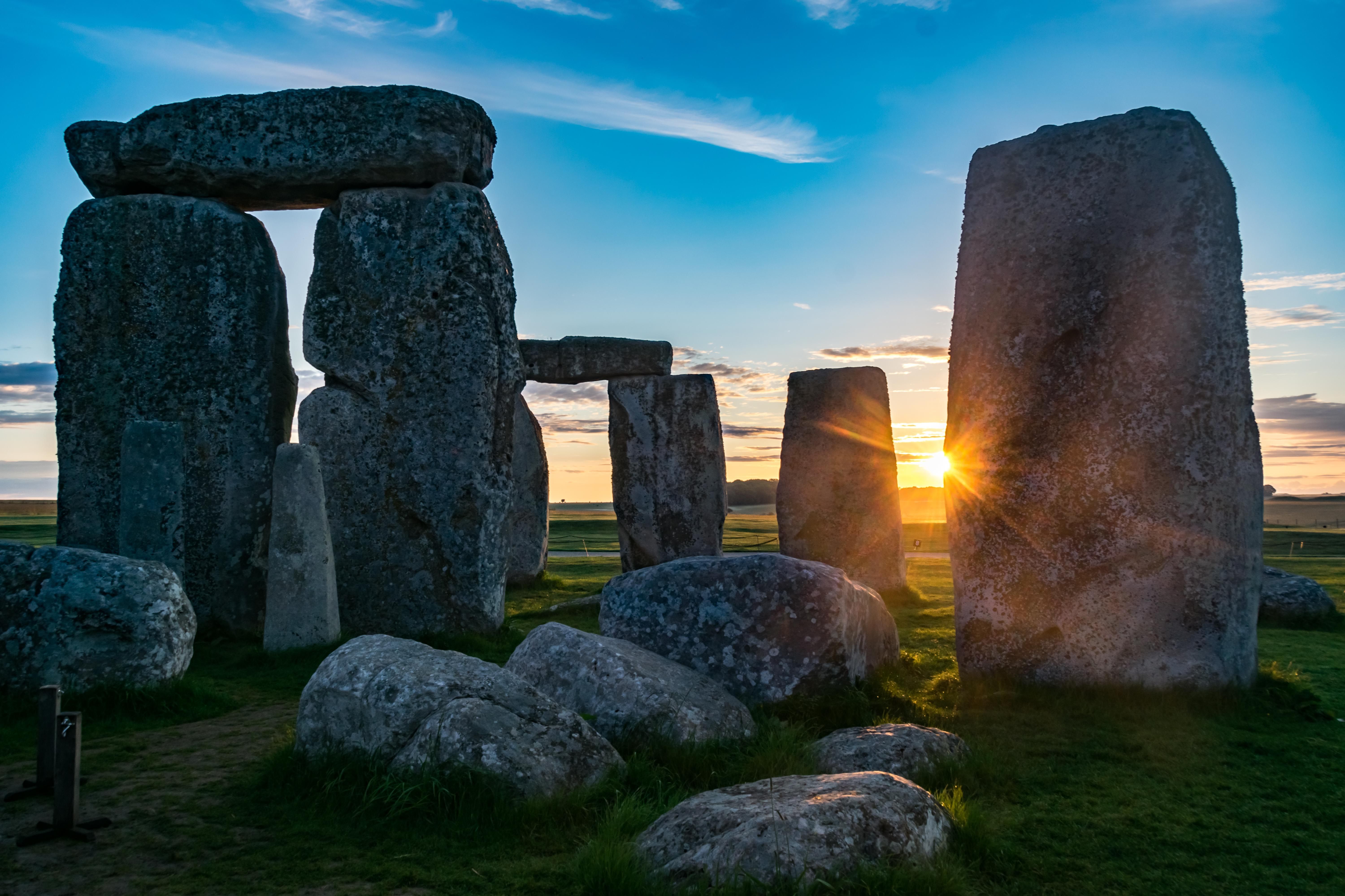 Sun peeking through one of the Sarsen stones a Stonehenge
