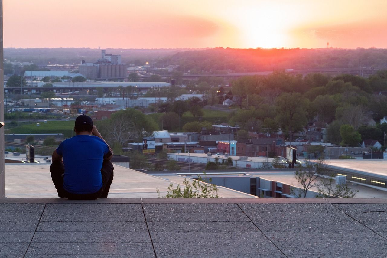 Man watching the sunset over Kansas City