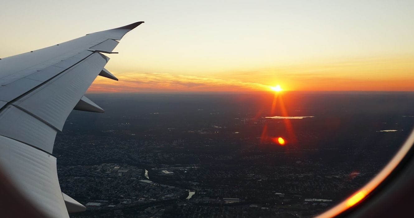 View out of an airplane window at sunset